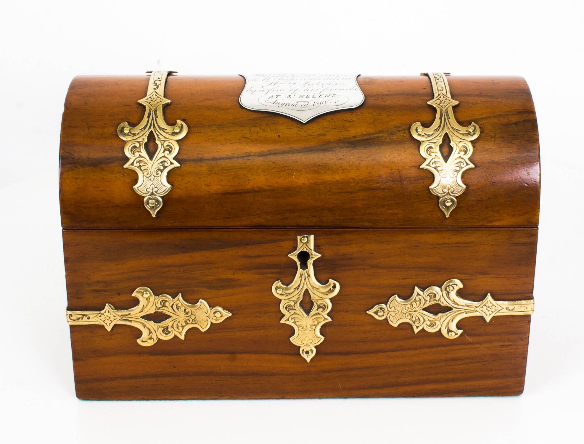 This is a superb antique Victorian walnut stationery box of domed form with elaborate decorative brass mounts, circa 1860 in date.

The hinged domed lid opens to reveal a silk and paper lined divided interior which will accommodate all your