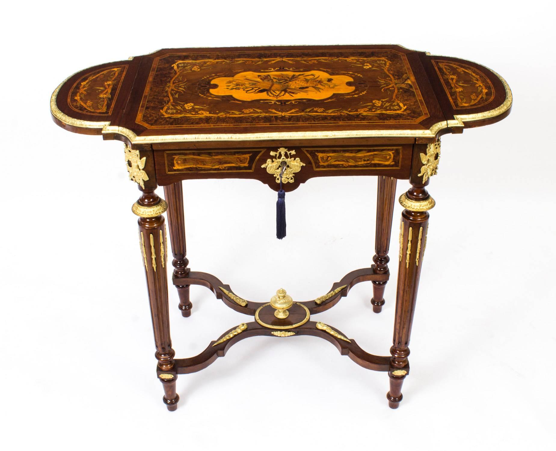 This is a beautiful antique French Louis XV Revival marquetry ormolu-mounted Poudreuse or writing table, circa 1860 in date.

The stunning marquetry lift up top is fitted with a mirror on the underside and has a flap on each side and they can be