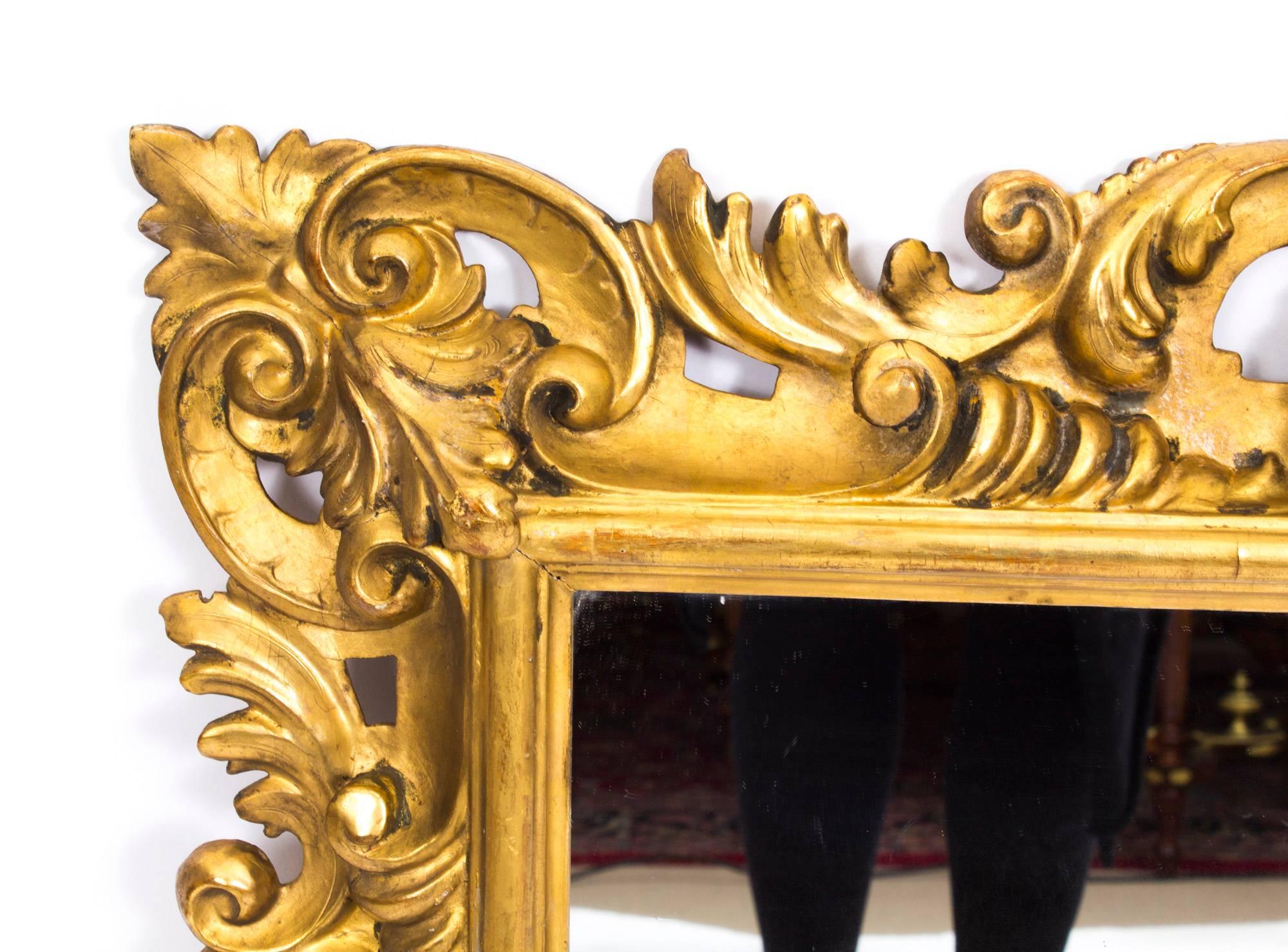 This is a beautiful antique Italian Florentine giltwood mirror, dating from the late 19th century.

The rectangular original mirror plate is within a pierced scrolling foliate and shell carved frame.

This is a very decorative item which will