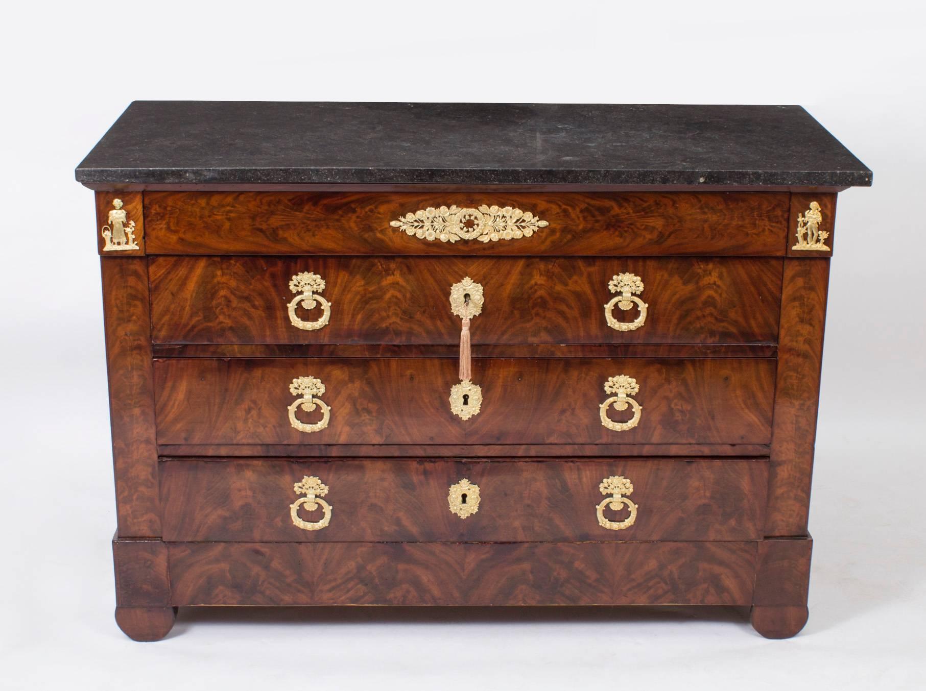This is a stunning antique French restoration period flame mahogany commode, circa 1820 in date.

It has a frieze drawer over three large and capacious full width drawers, all with the most wonderful ormolu handles escutcheons and mounts, and it