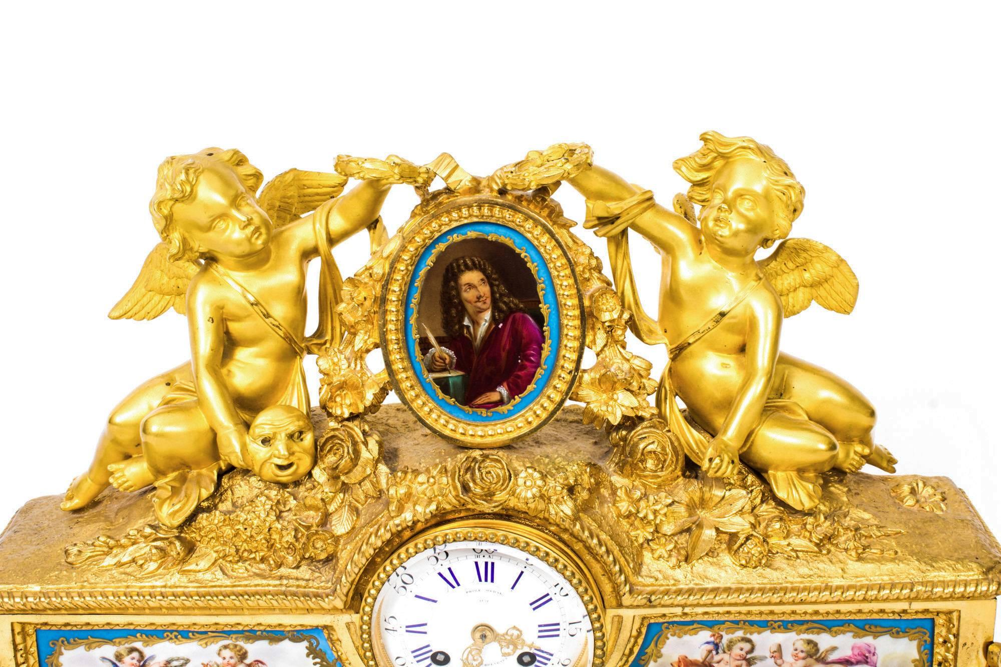 This is a superb antique French gilt bronze mantel clock with a profusion of Bleu Celeste porcelain panels in the Sèvres manner, circa 1860 in date. 

The case mounted with two cherubs holding wreaths representing theatre, flanking an oval Bleu