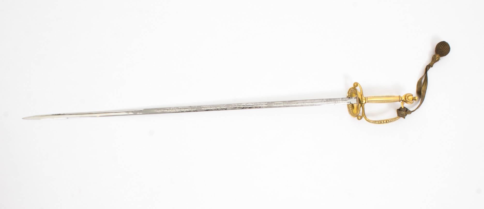 A superb Rapier by McCallan, St James Street, London, late 19 century in date.

It features a gilt bronze hilt with a gilt bronze mounted leather scabbard.

The engraved blade is double edged and it comes with it's original gold thread work
