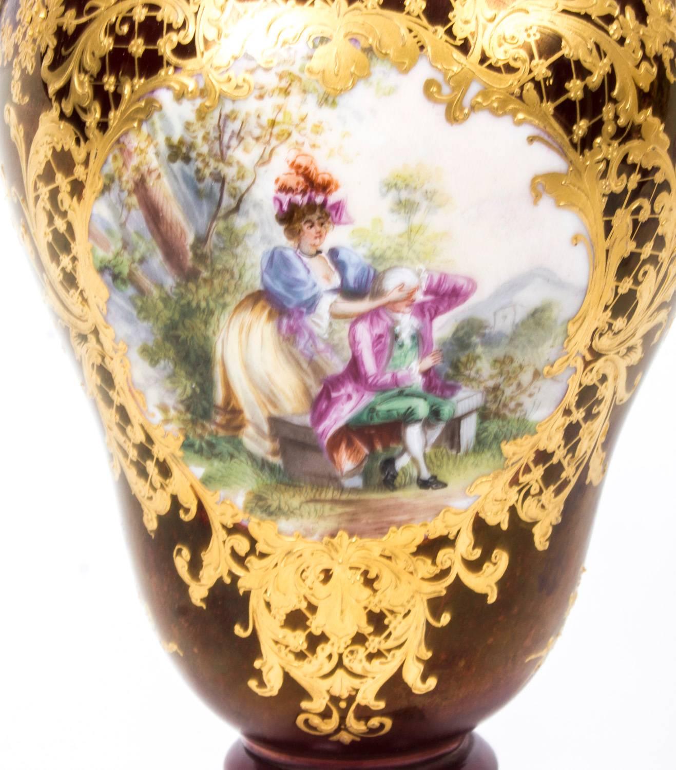 This is a beautiful antique pair of Helena Wolfsohn Dresden Porcelain vases, circa 1880 in date.

Of baluster form each with superb gilded highlights in relief and hand-painted romantic panels of courting couples on a rich burgundy ground.

With