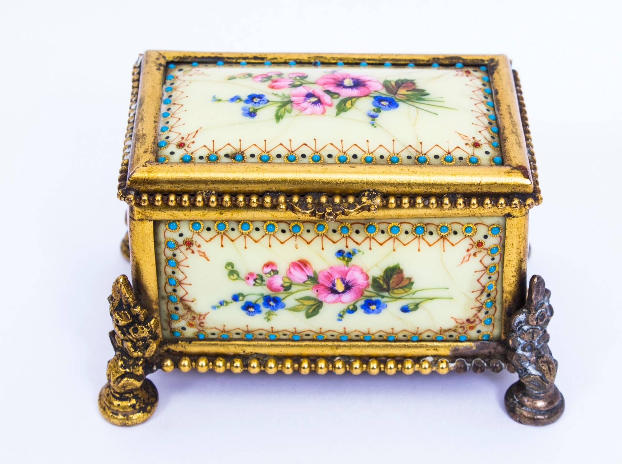This is a beautiful antique French Limoges ormolu-mounted enamel rectangular bombe' shaped table casket, circa 1870.

The casket has yellow enamel panels that are decorated with poppies and country flowers, within jewelry turquoise cabachon