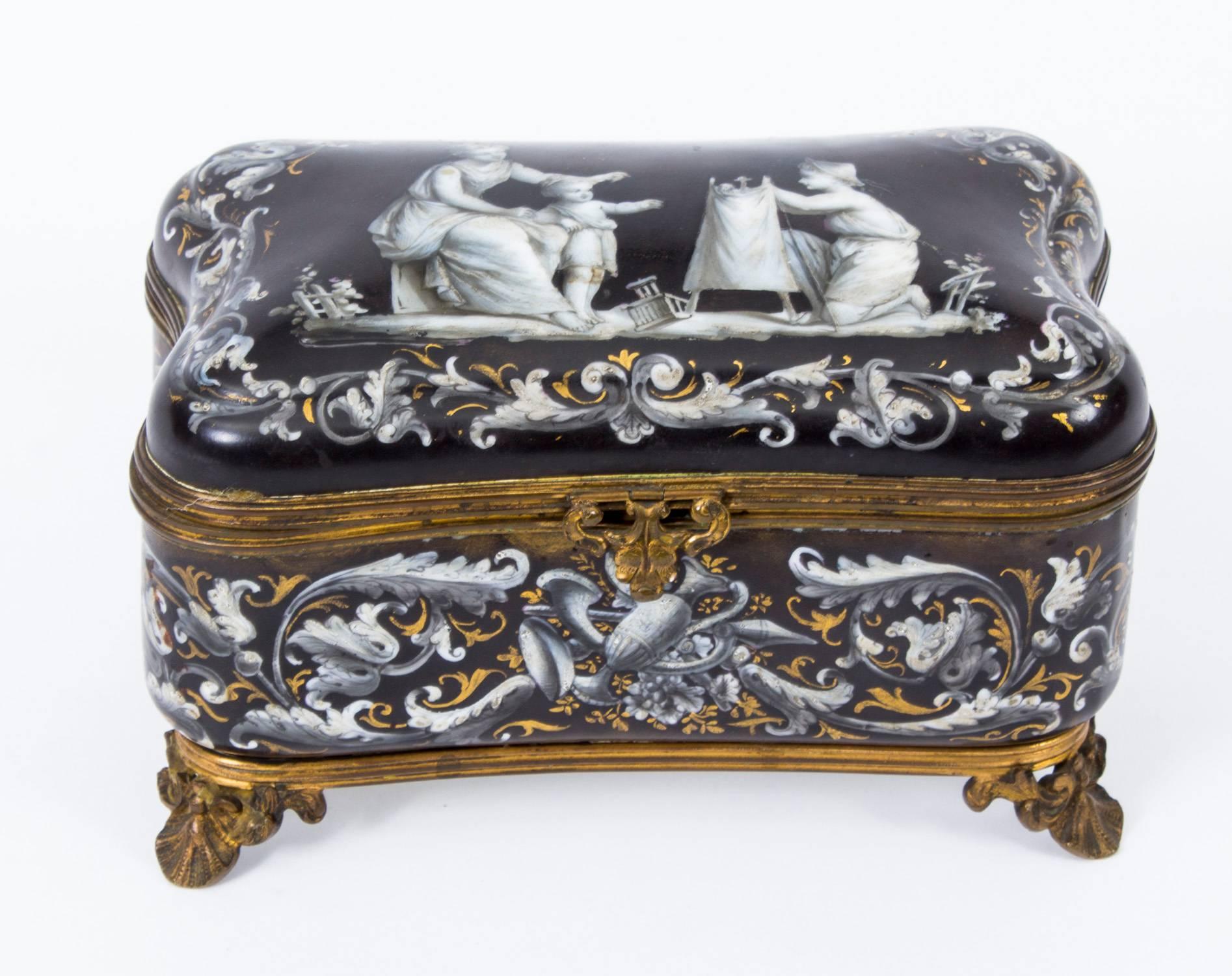 This is a beautiful antique French enamel ormolu-mounted rectangular casket, circa 1870 in date.

The casket is decorated with grisaille in striking shades of grey on a black ground, depicting children at play. It is framed within a tooled gilded