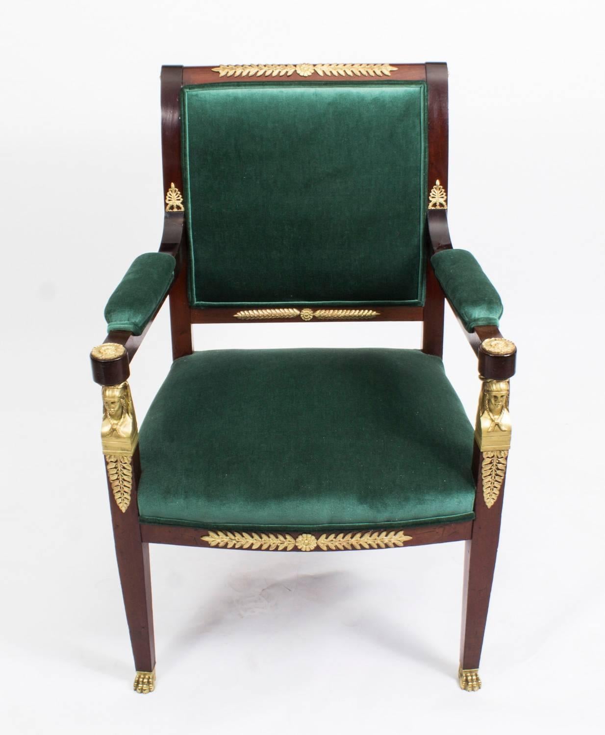 This is a beautiful antique Napoleon III mahogany fauteiul or open armchair in the fabulous Empire Style, circa 1850 in date. 

The mahogany is beautiful in colour and has been embellished with striking ormolu mounts. The padded arms have gilt