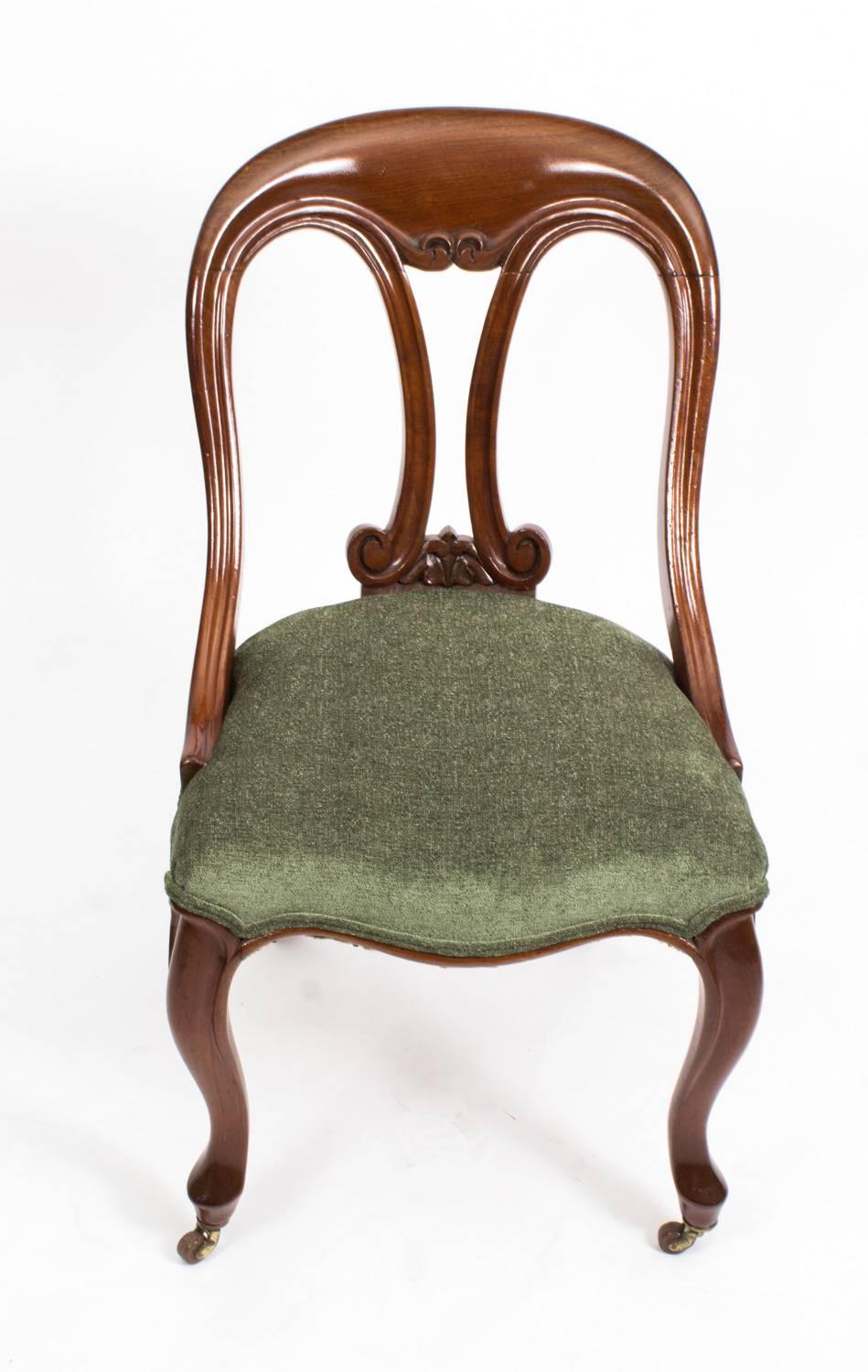 This is a superb pair of antique Victorian mahogany fiddle back side chairs, circa 1850 in date.

These chairs have been masterfully crafted in beautiful mahogany. They have carved back splats with an elegant green fabric upholstery and stand on