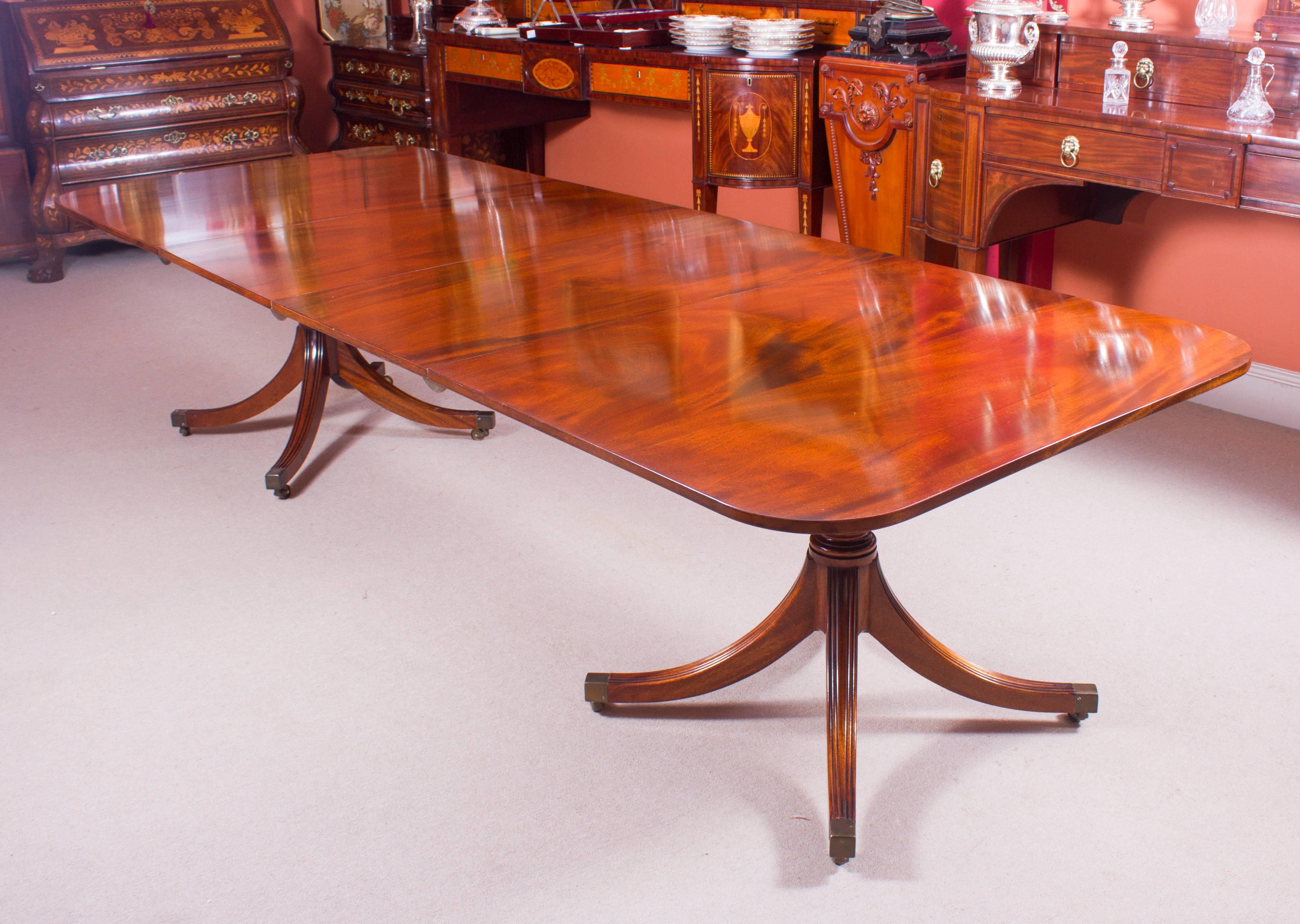 This is fabulous vintage dining set which includes a Regency style dining table, by William Tillman, and ten Regency style Hepplewhite dining chairs. 

The beautiful Regency style dining table is made of solid flame mahogany and the twin bases are