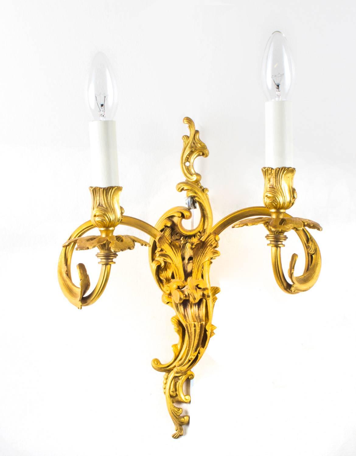 This is a stunning set of four French Rococo twin branch ormolu wall lights, circa 1920.

Purchased from a fabulous apartment in Hampstead, London and there is no mistaking their fabulous quality and design. They will soon instantly enhance the