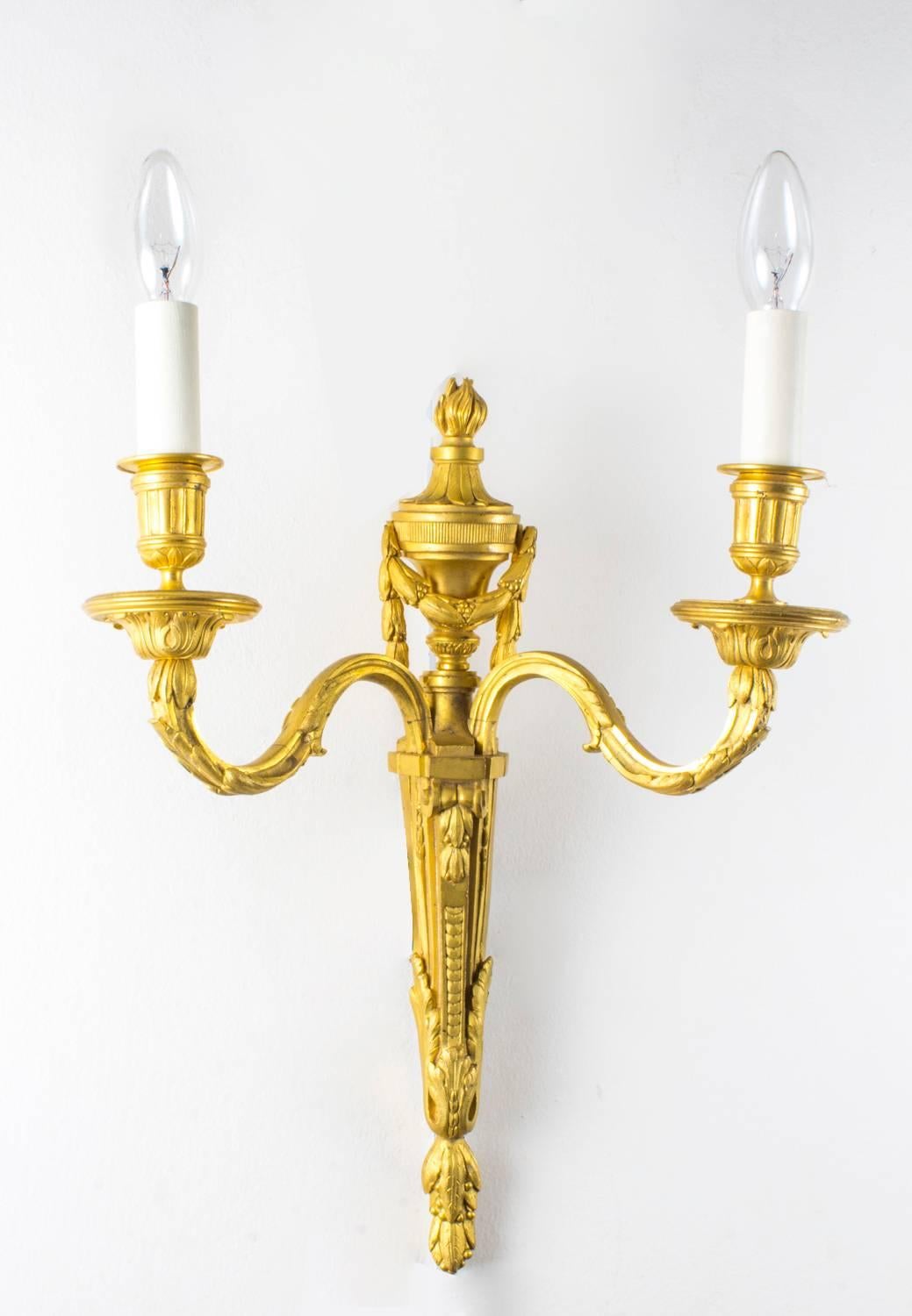 This is a stunning pair of antique gilded ormolu twin branch wall lights with flamimg torch decoration, dating from the late 19th century.

Purchased from a fabulous apartment in Hampstead, London.

There is no mistaking their unique quality and