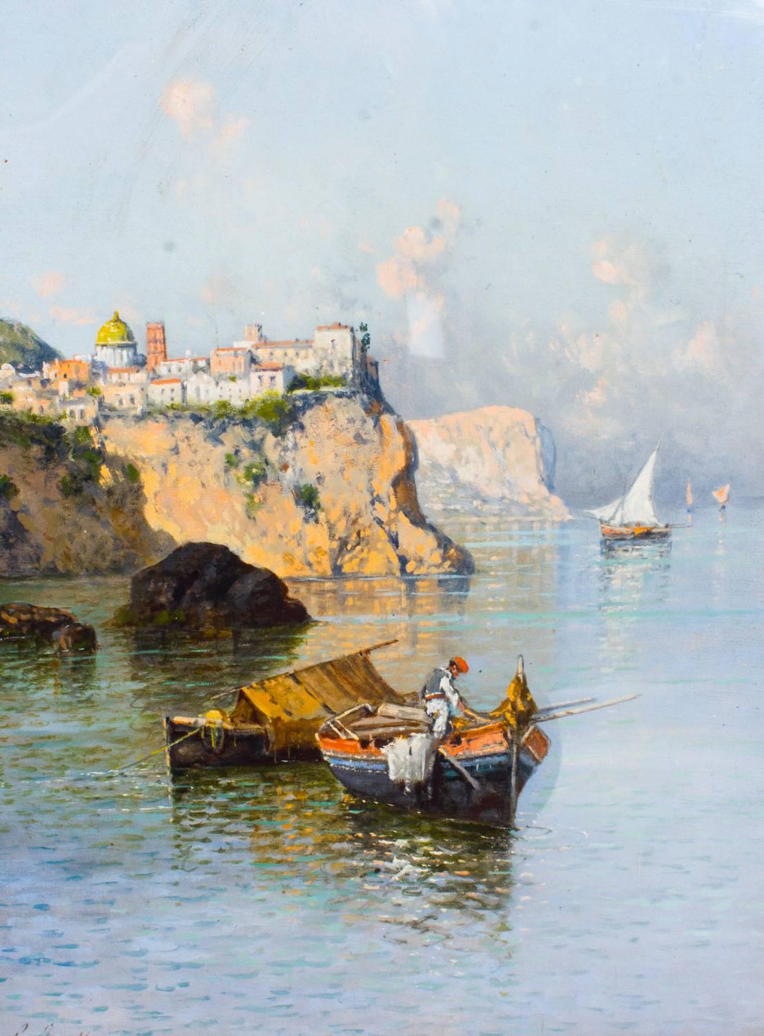 This is a beautiful antique oil on canvas seascape painting by Giuseppe Carelli (Italian 1858-1921) of a coastal scene near Naples in Southern Italy, signed lower left.

This painting features fishermen in rowing boats and sail boats on calm