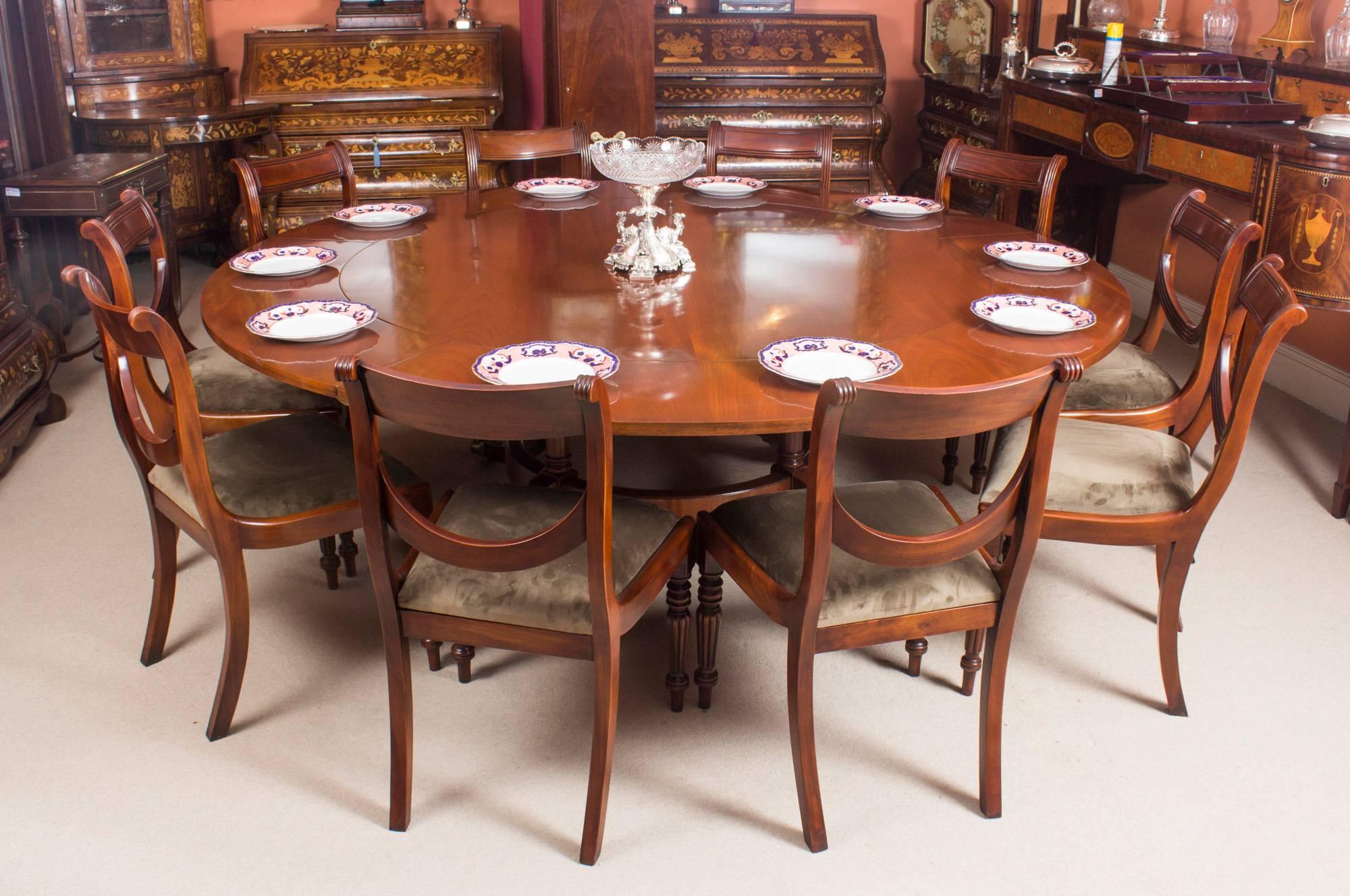 This beautiful dining set comprises a Regency Revival Jupe style dining table mid-20th century in date, with the matching set of ten Regency style dining chairs.

The table has a solid mahogany top that has five additional leaves that can be added
