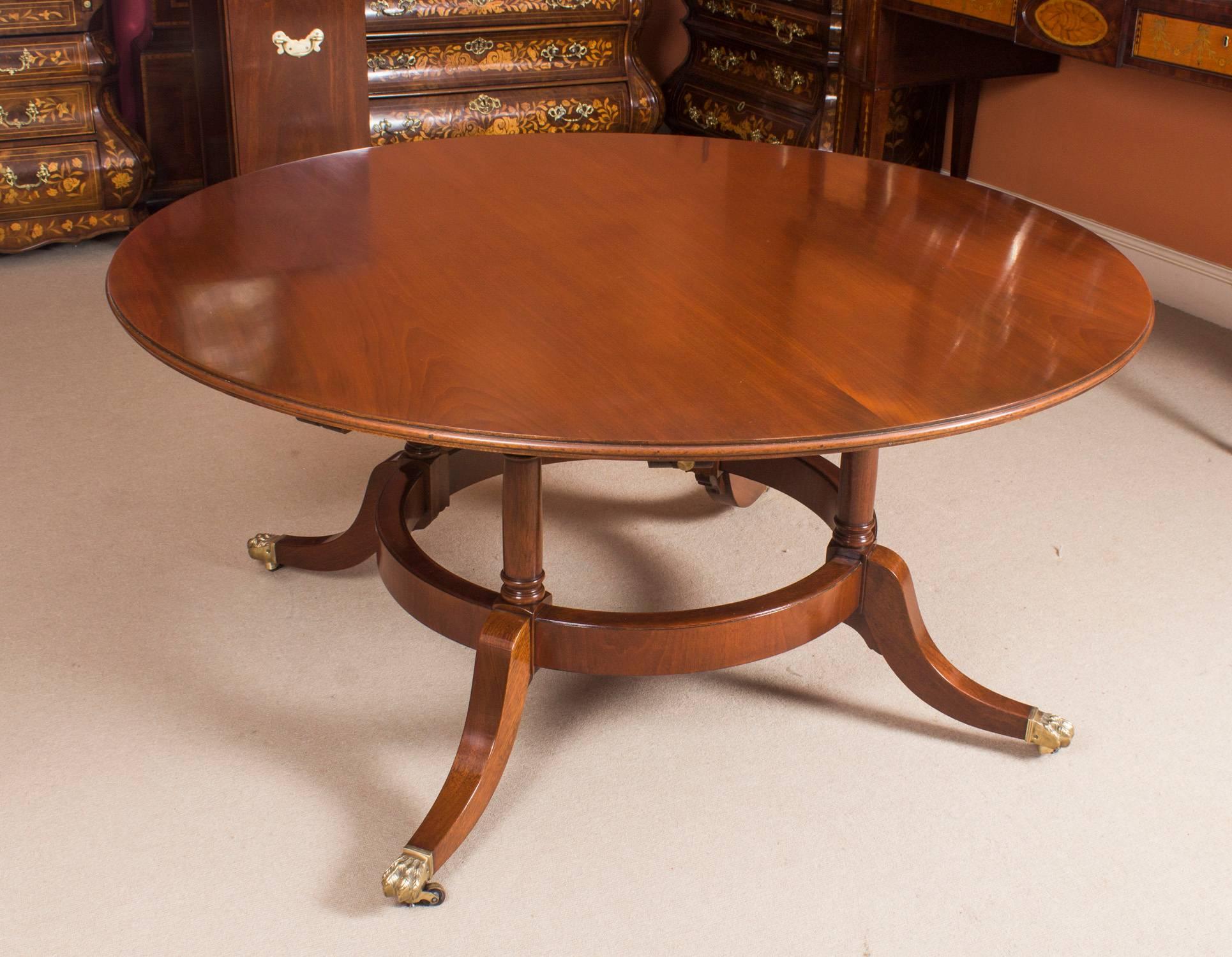 This is a beautiful Regency Revival Jupe style dining table, dating from the mid-20th century.

The table has a solid mahogany top that has five additional leaves that can be added around the circumference. It is very stable as it has a circular