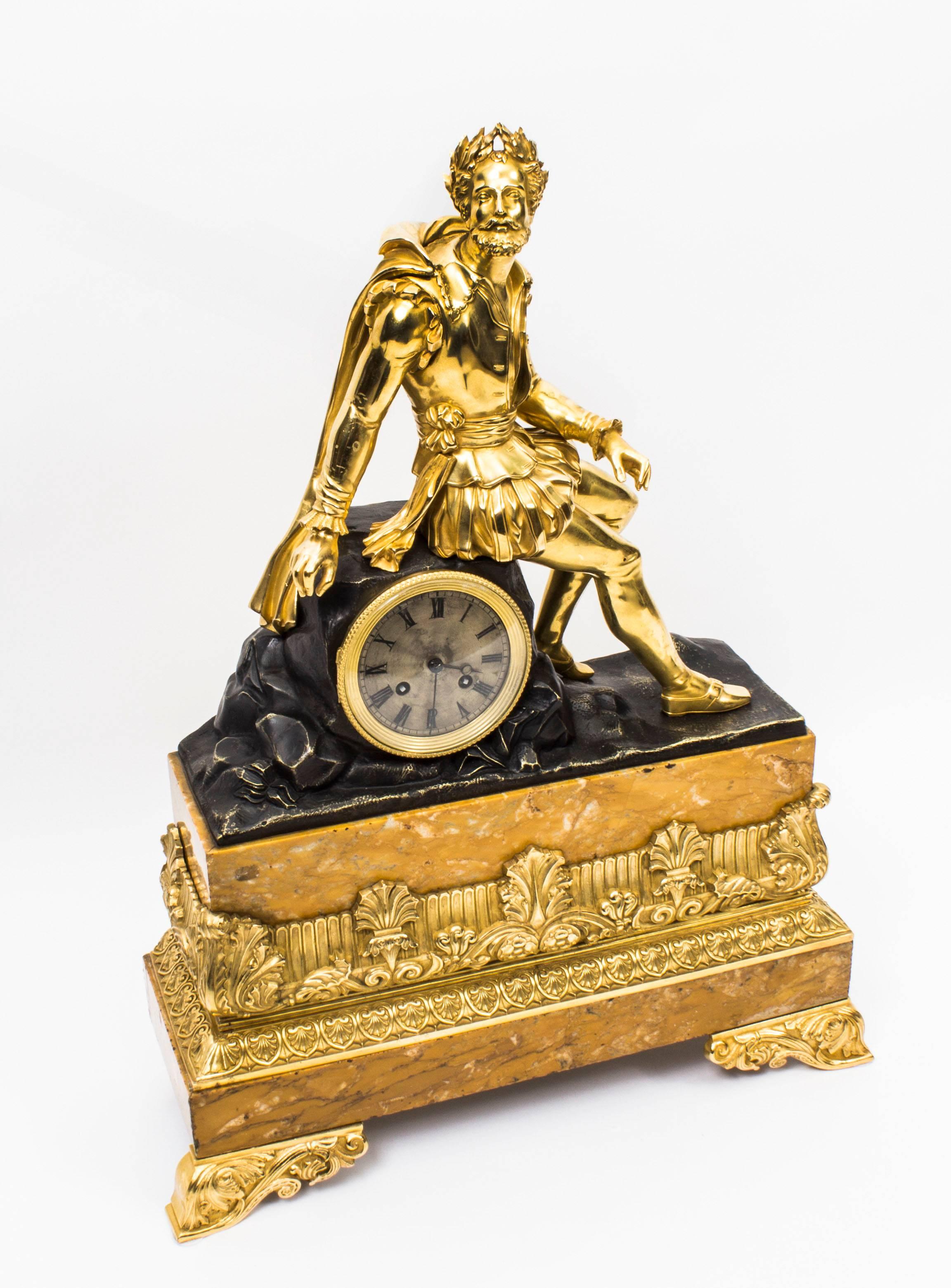 This is a fabulous ormolu, bronze and Siena marble mantel clock circa 1850 in date.

This beautiful clock features an ormolu figure dressed in a Renaissance costume wearing a laurel wreath, casually sitting on a bronze rock with an inset Roman