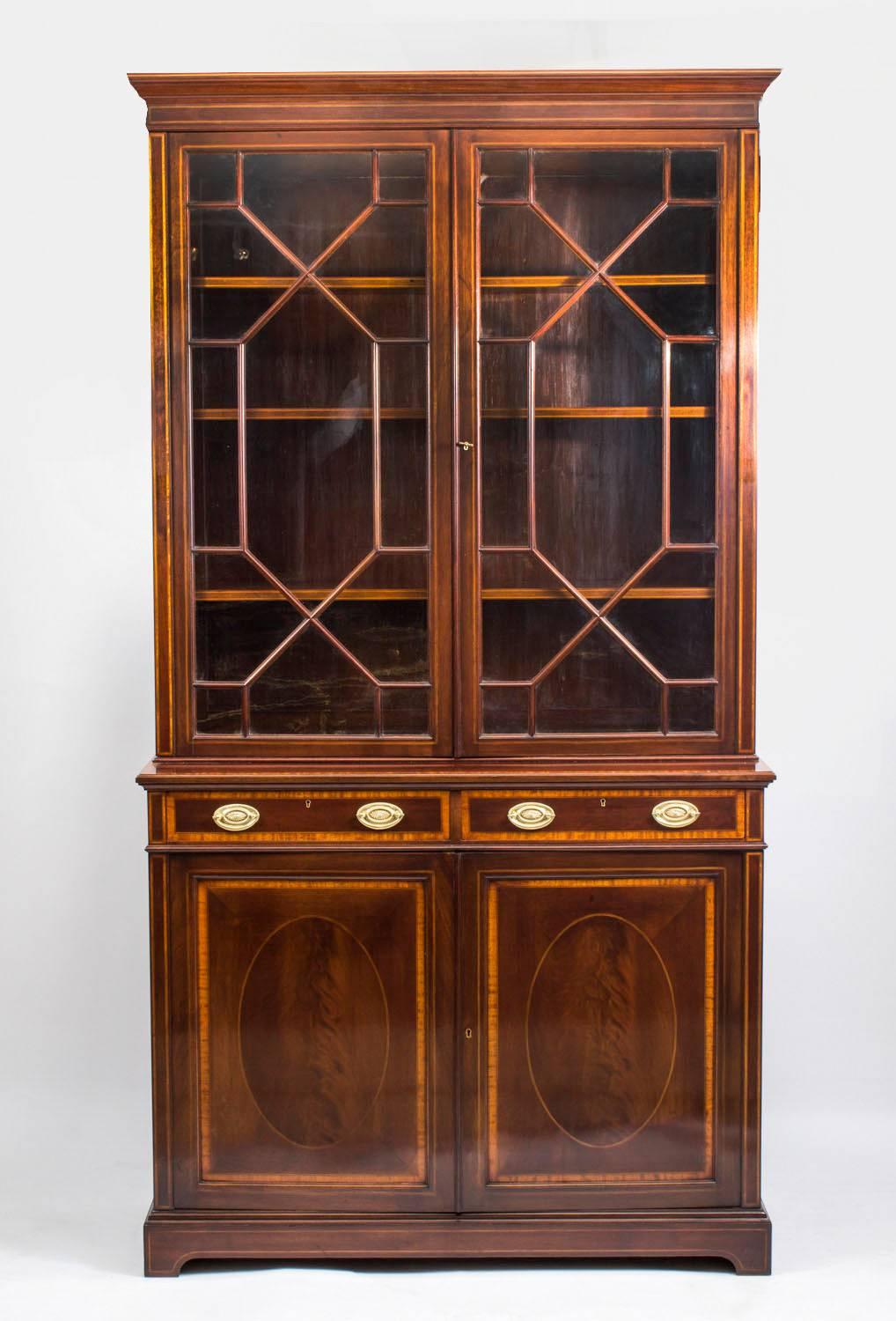 This is an absolutely stunning antique Edwardian flame mahogany and satinwood inlaid bookcase by Maple & Co, circa 1900 in date.

The bookcase bears the ivorine plaque of the renowned maker and retailer Maple & Co.

This fabulous bookcase features a