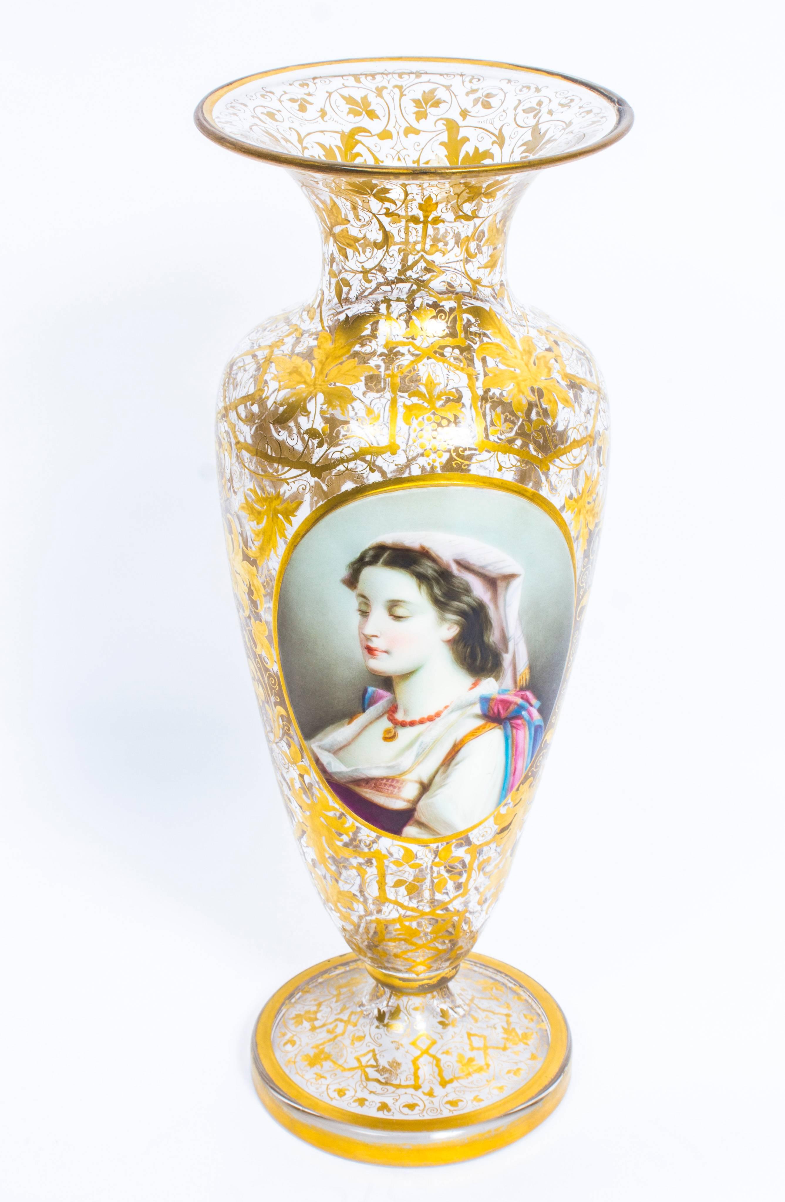 This is a stunning pair of late 19th century Bohemian opaline flashed and gilded crystal portrait vases.

The crystal vases are profusley decorated with exquisite foliate gilding, are of tapering baluster form with flared necks and raised on ring