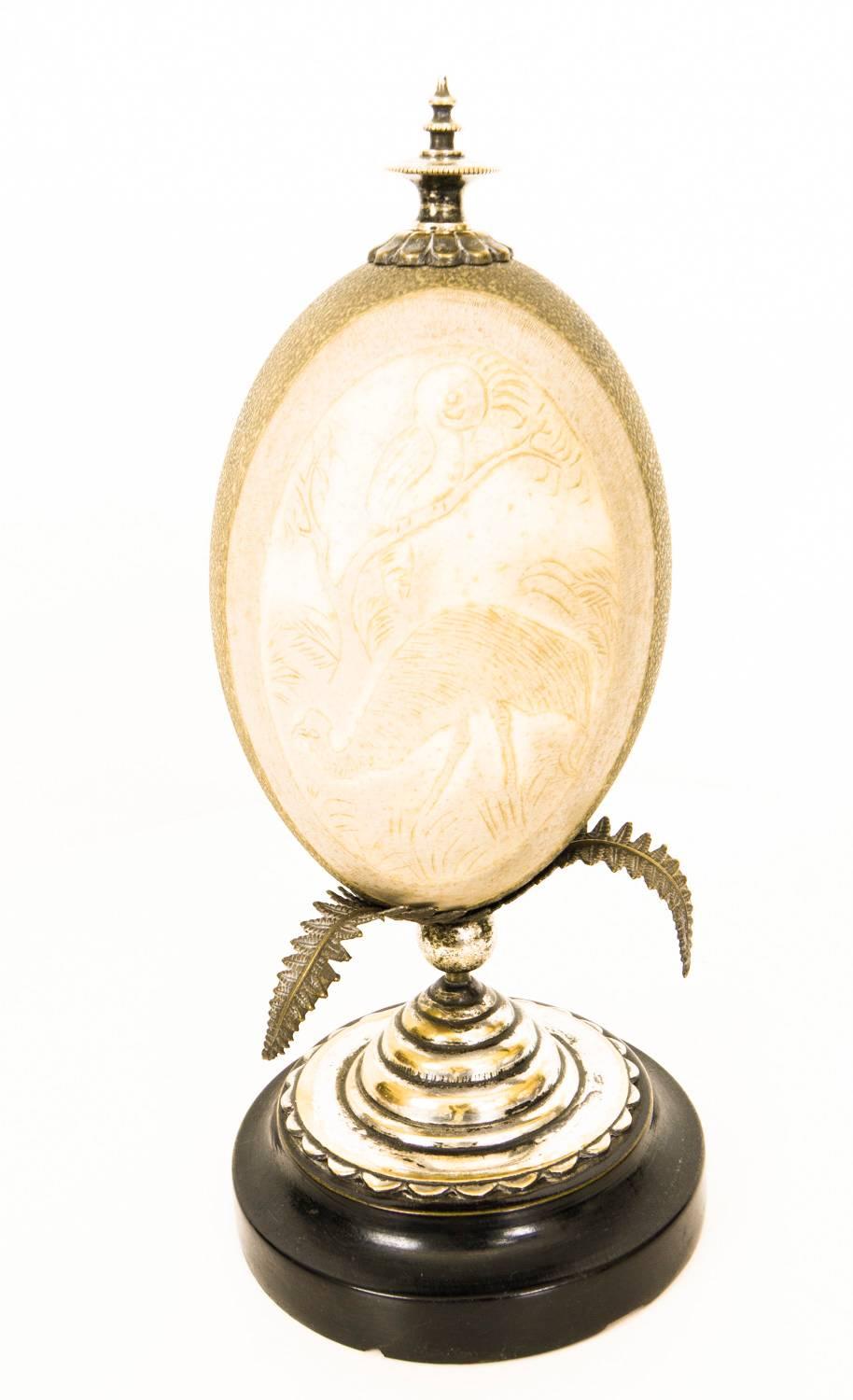 This is a wonderful antique pair of Australian cameo carved Emu eggs on silver plated and ebonised stands, 19th Century in date.

This beautiful pair of carved emu eggs are each topped with a finial and rest on silver plated palm leaf mounts on