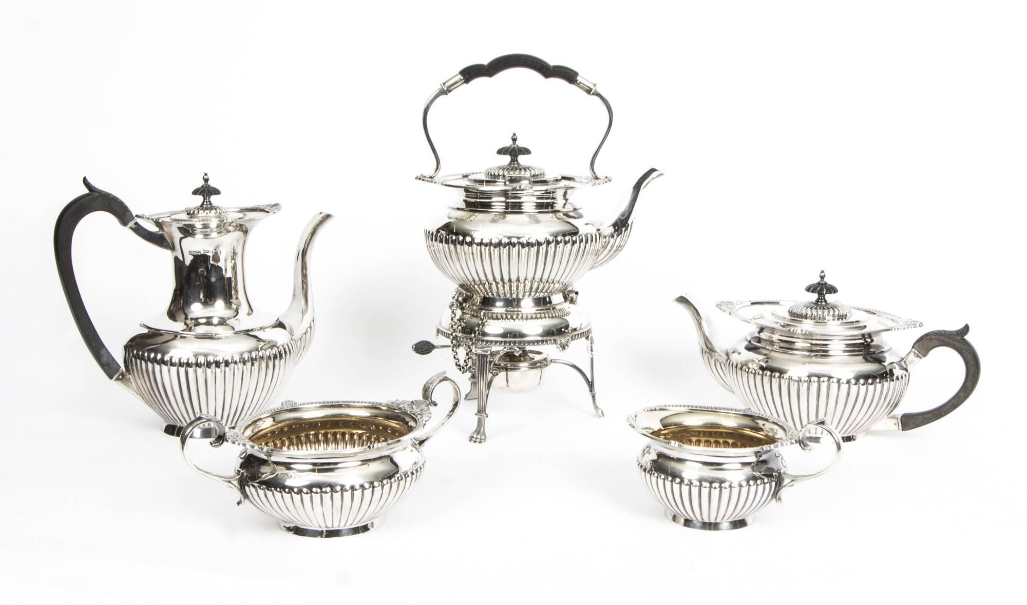 This wonderful set comprises a superb antique English Antique sterling silver five piece tea and coffee set with hallmarks for Sheffield 1908 and the mark of the renowned retailer and silversmith Walker & Wall.

The set comprises a coffee pot, a