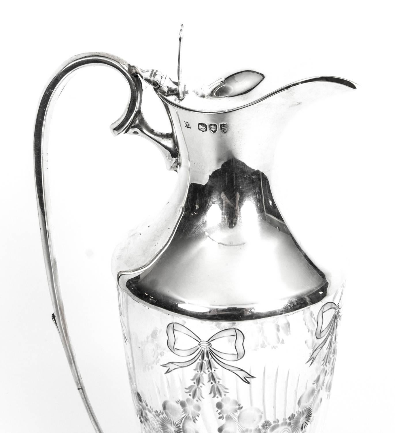 A magnificent antique Victorian Sterling Silver and cut crystal claret jug, with hallmarks for London 1893 and the makers mark of the renowned silversmith William Hutton.

The piece is of baluster form, has a circular foot and the glass is