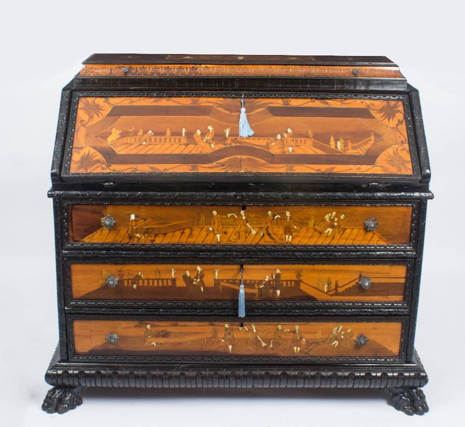 This is a fabulous continental North Italian fruitwood and marquetry bureau, dating from the late 18th century. 

With stunning carved ebonised decoration, foliate marquetry and beautifully bone inlaid with figures in various Royal Court scenes.

It