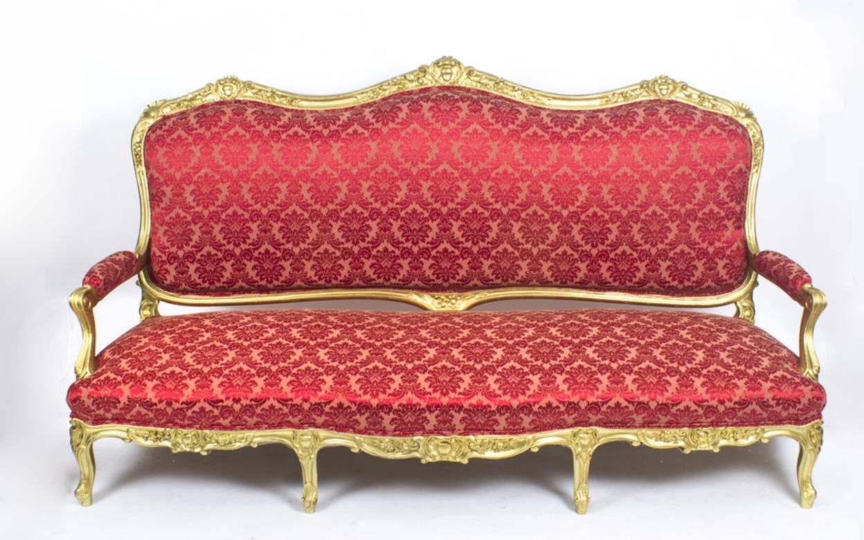 This is a magnificent large antique French Louis XVI Revival four seater giltwood Canape', circa 1870 in date.

The settee has been beautifully hand carved and gilded and features trails of foliage, scroll armrests and is raised on short cabriole