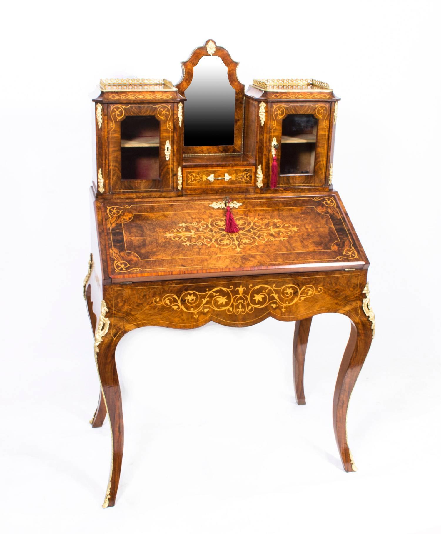 This is a beautiful antique Victorian burr walnut and inlaid Bonheur Du Jour, or Ladies writing desk, circa 1860 in date. 

The gorgeous grain and color of the walnut, the fabulous inlay and the exquisite ormolu mounts ensure that this bureau de