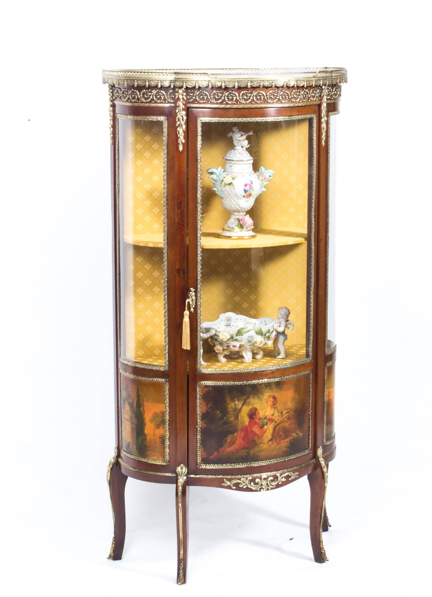 This is a stunning antique French Vernis Martin display cabinet in the Louis XV manner, circa 1900 in date.

It has exquisite hand-painted decoration, is further decorated with exquisite ormolu mounts and has an inset marble top with an attractive