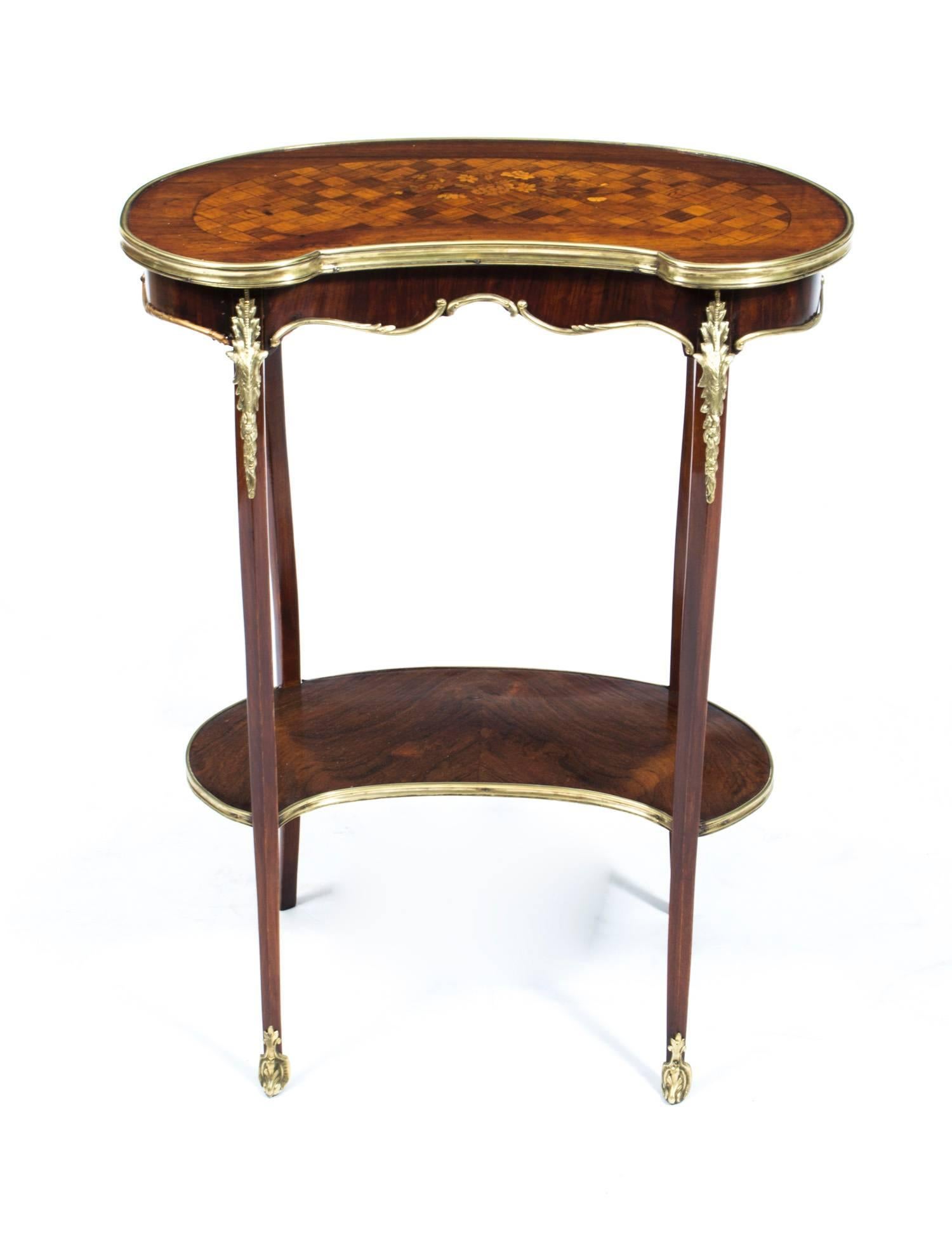 This is a delightful antique French rosewood and parquetry kidney shaped occasional table with ormolu mounts, in Louis XV style and circa 1900 in date.

This beautiful table is made from rosewood and features geometric parquetry inlay with floral