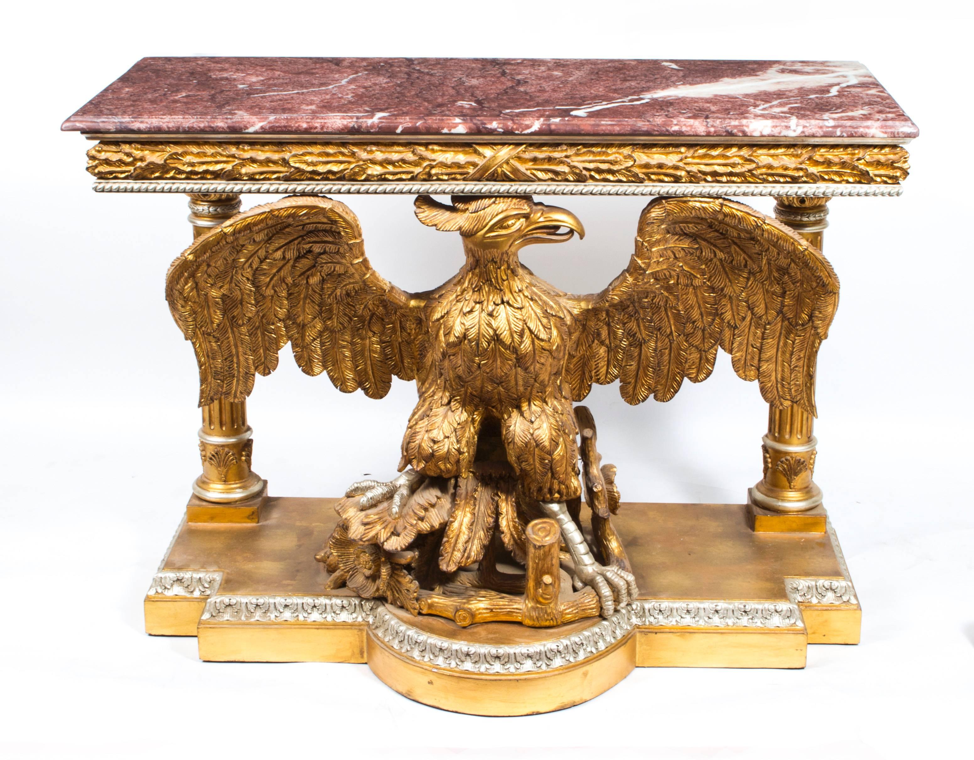 A highly ornate and absolutely stunning pair of vintage carved giltwood and silvered console tables in the manner of William Kent and dating from the second half of the 20th century.

They have stunning Rosso Carpazzi marble tops and are supported