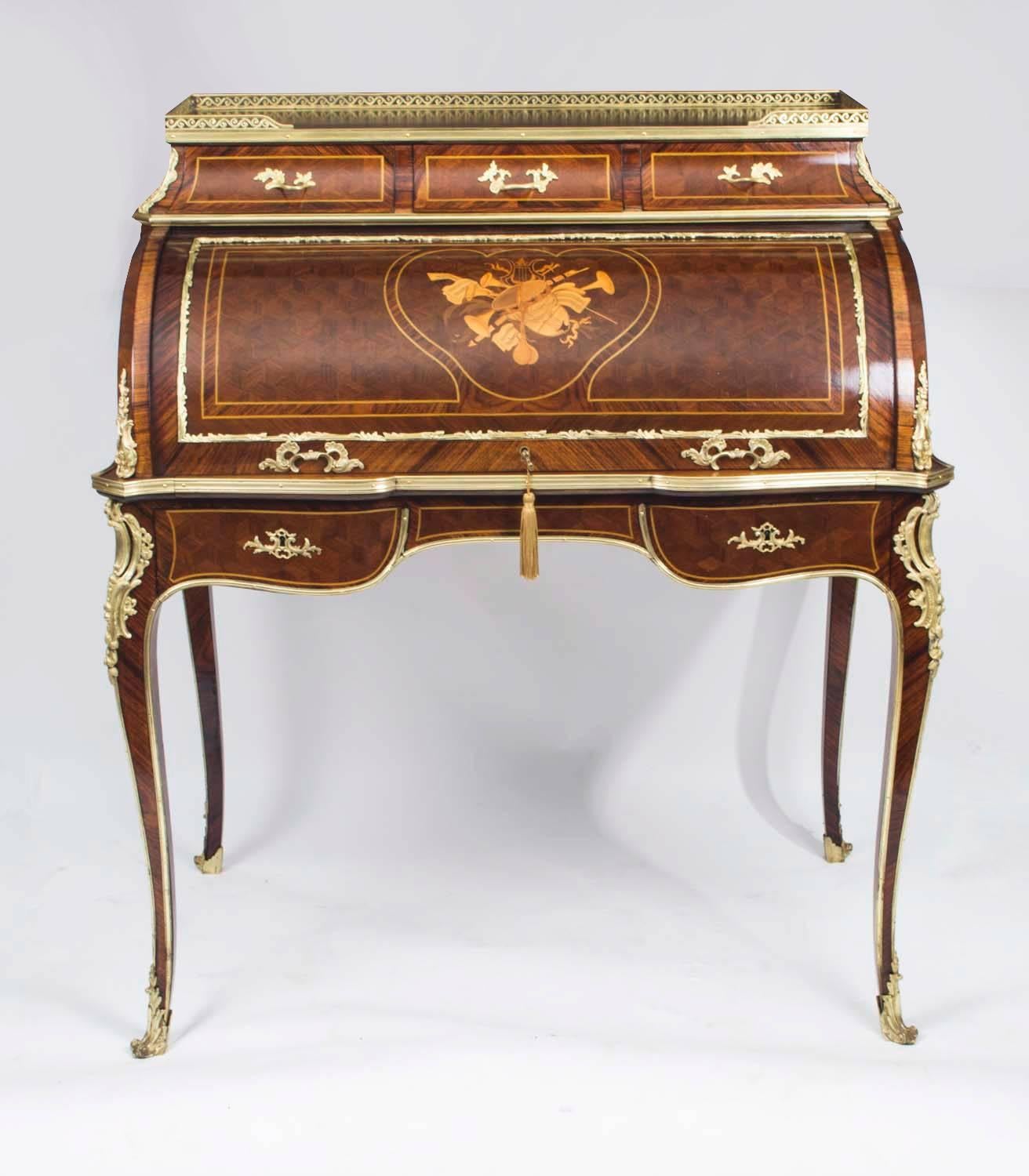 This is a gorgeous antique French kingwood, marquetry and parquetry Louis XV Revival secretaire a cylindre, circa 1890 in date.

This gorgeous cylinder bureau has a stunning marquetry panel of musical instruments, finished in exotic woods, on the