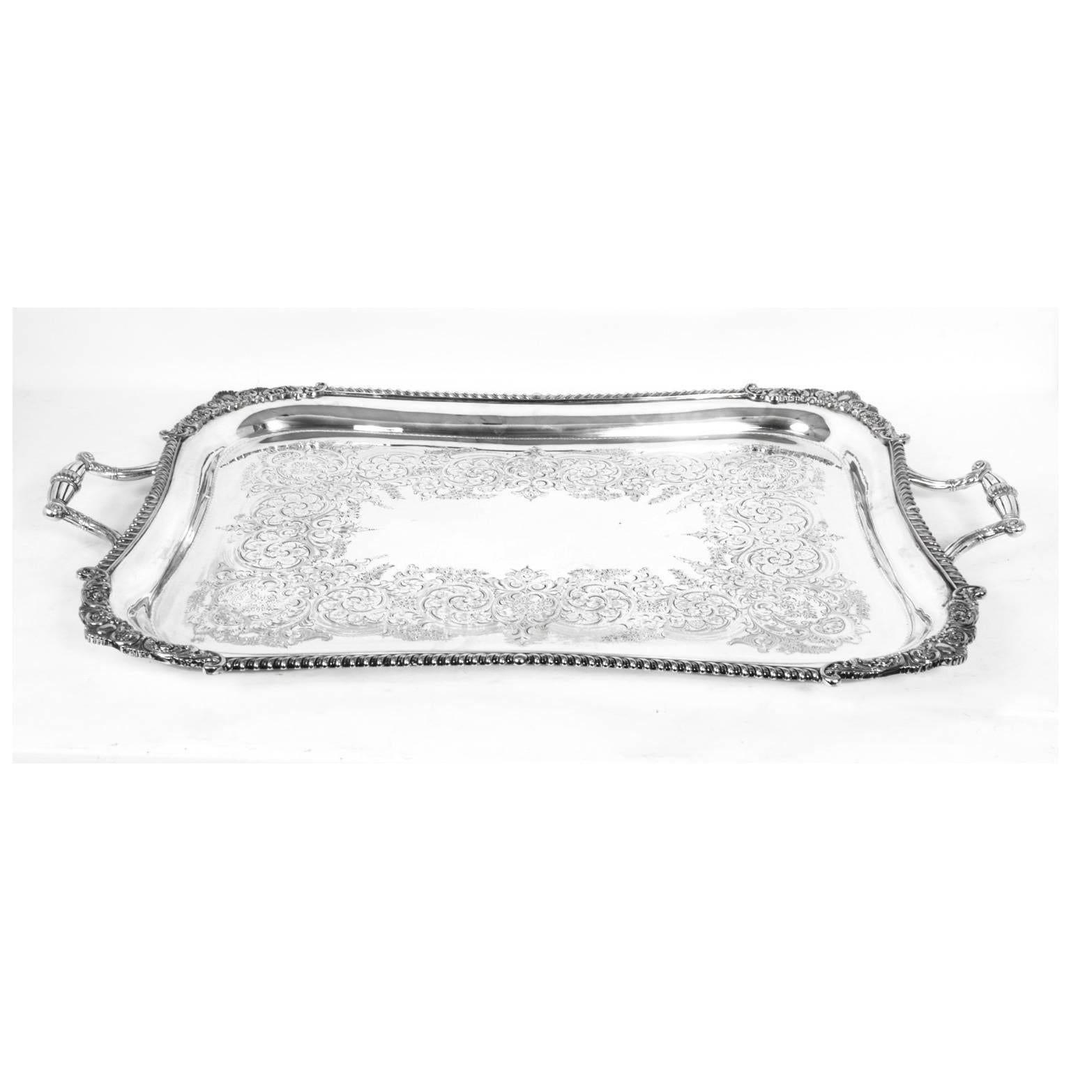 This is a lovely antique English Victorian silver plated tray with makers marks for the eminent silversmith William Hutton & Sons of West Street Sheffield, circa 1870.

This large rectangular silver plated tray features a deep set, decorative