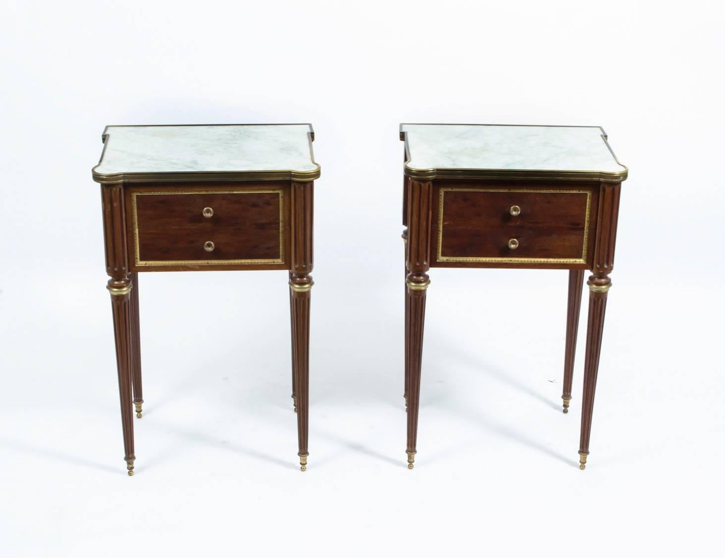 A thoroughly delightful pair of antique French bedside cabinets, circa 1900 in date, typical of the Empire Revival style which was especially popular at the time.

They are have been accomplished in mahogany with gilded ormolu mounts and stunning