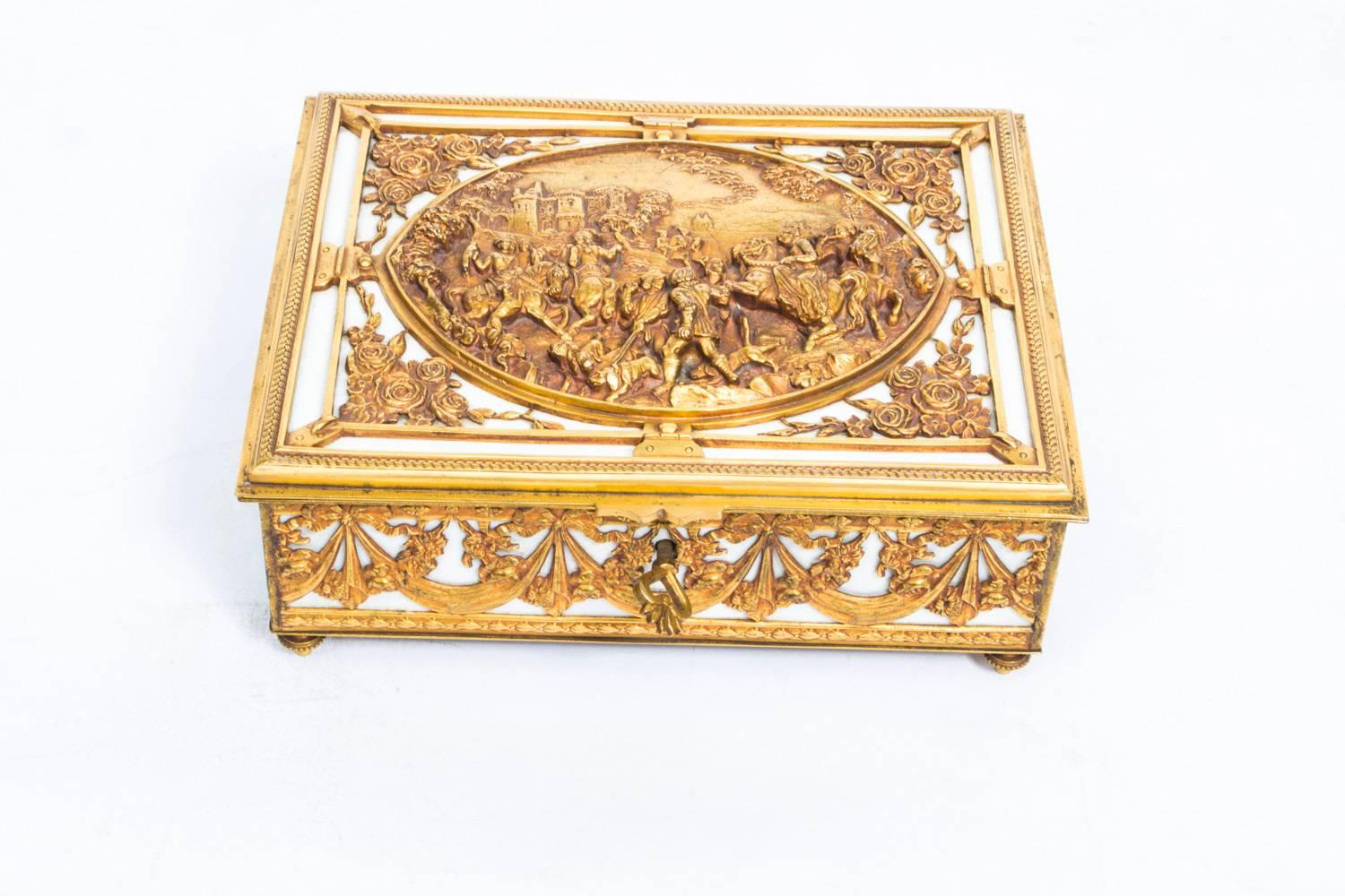 This is a beautiful ivory and ormolu mounted casket, the hinged lid with oval three dimensional panel cast with hunting scene, hounds and figures on horseback, castle beyond, floral spandrels within plain borders and clasps.

The front, sides and