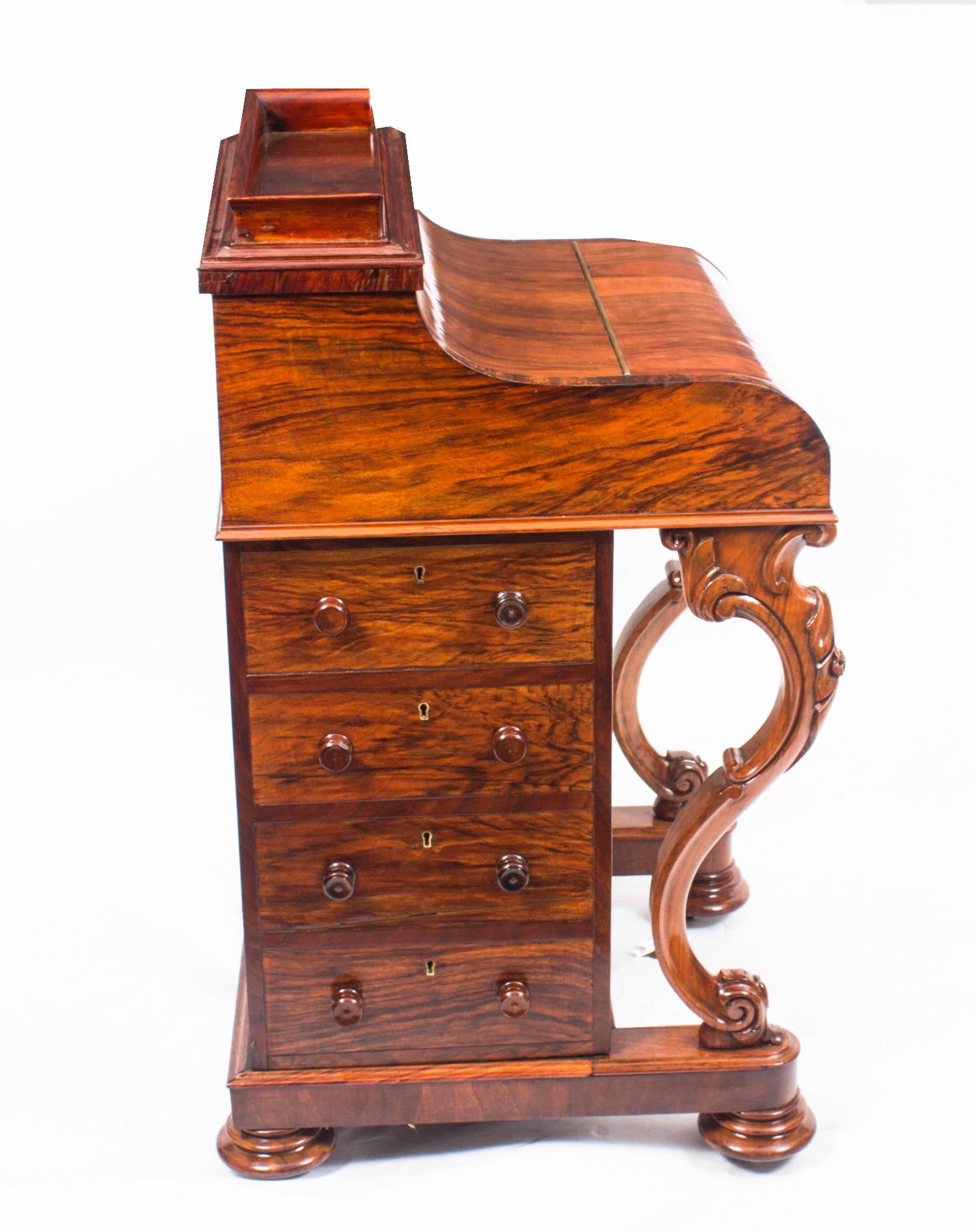We are pleased to be able to offer for sale this very attractive example of an antique Davenport Desk. It is supplied with the original tooled, gilded, leather writing inset still intact and the desk stands on a pair of sturdy solid walnut cabriole