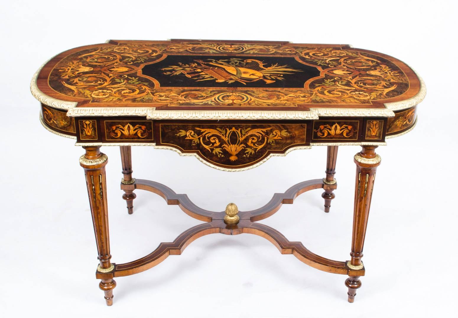 This is a gorgeous antique French ormolu mounted marquetry burr walnut, bureau plat or centre table, circa 1850 in date.

This fabulous table features beautiful marquetry decoration of walnut, gonzalo alves and purple heart with elegant ormolu