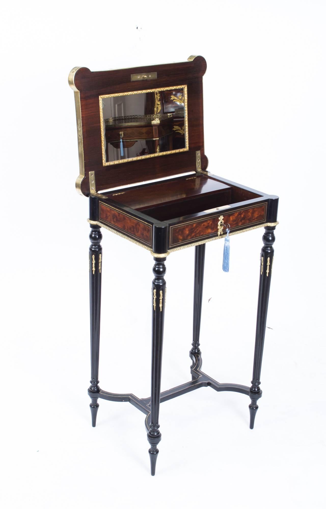 This is a beautiful antique French burr walnut and ebonized occasional work/dressing table, circa 1860 in date. The brass lock, complete with key, bears the inscription of the maker “Tahan Paris,” Alphonse Tahan was the master cabinet maker to