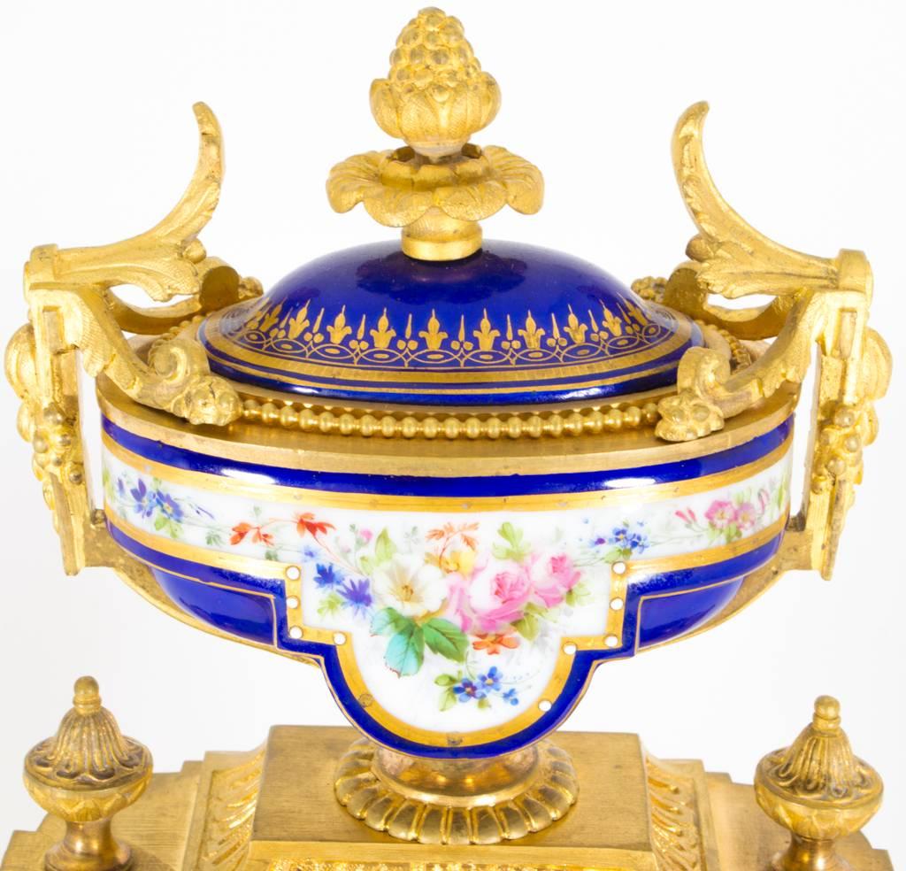 This is a beautiful antique French ormolu mantel clock with a profusion of royal blue porcelain inset panels in the Sèvres manner, circa 1860 in date.

The movement is stamped with serial number: 2337
The porcelain inset panels on the side and