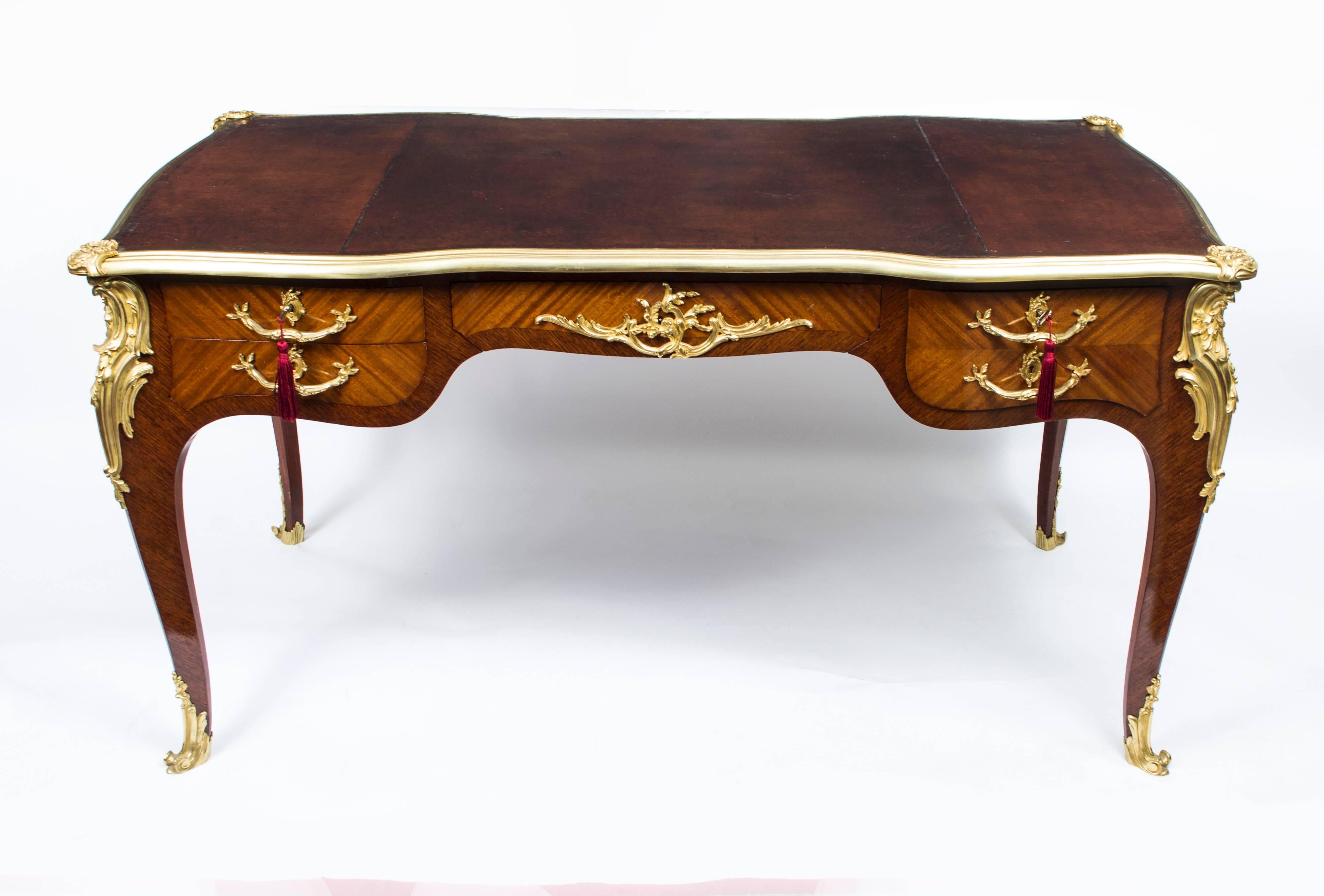 This is a gorgeous large antique French ormolu-mounted kingwood and flame mahogany bureau plat, circa 1870 in date.

Featuring fabulous decorative ormolu mounts this table is sure to get noticed wherever it is placed.

It has it's original inset