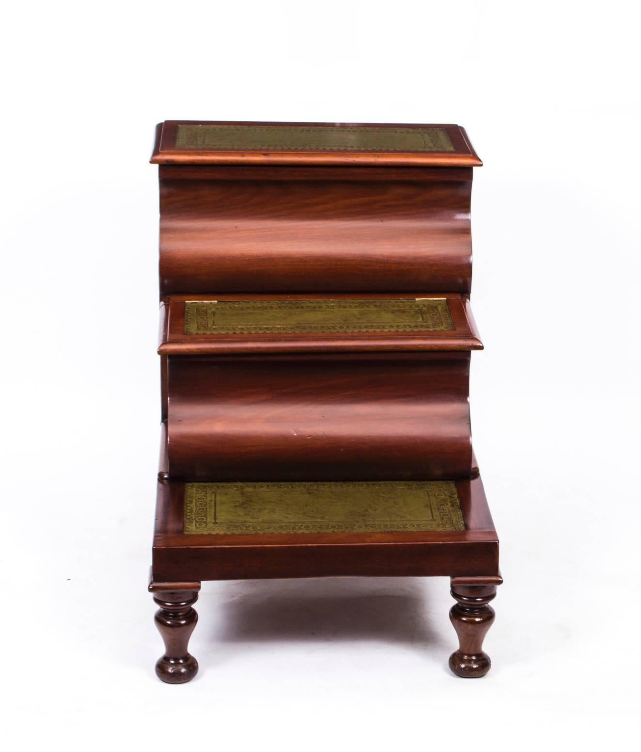This is a beautiful set of antique Victorian flame mahogany library or bed steps, circa 1870 in date.

The three steps have inset gilt tooled emerald green leather treads. The top and middle steps have hinged lids that provide storage and it stands