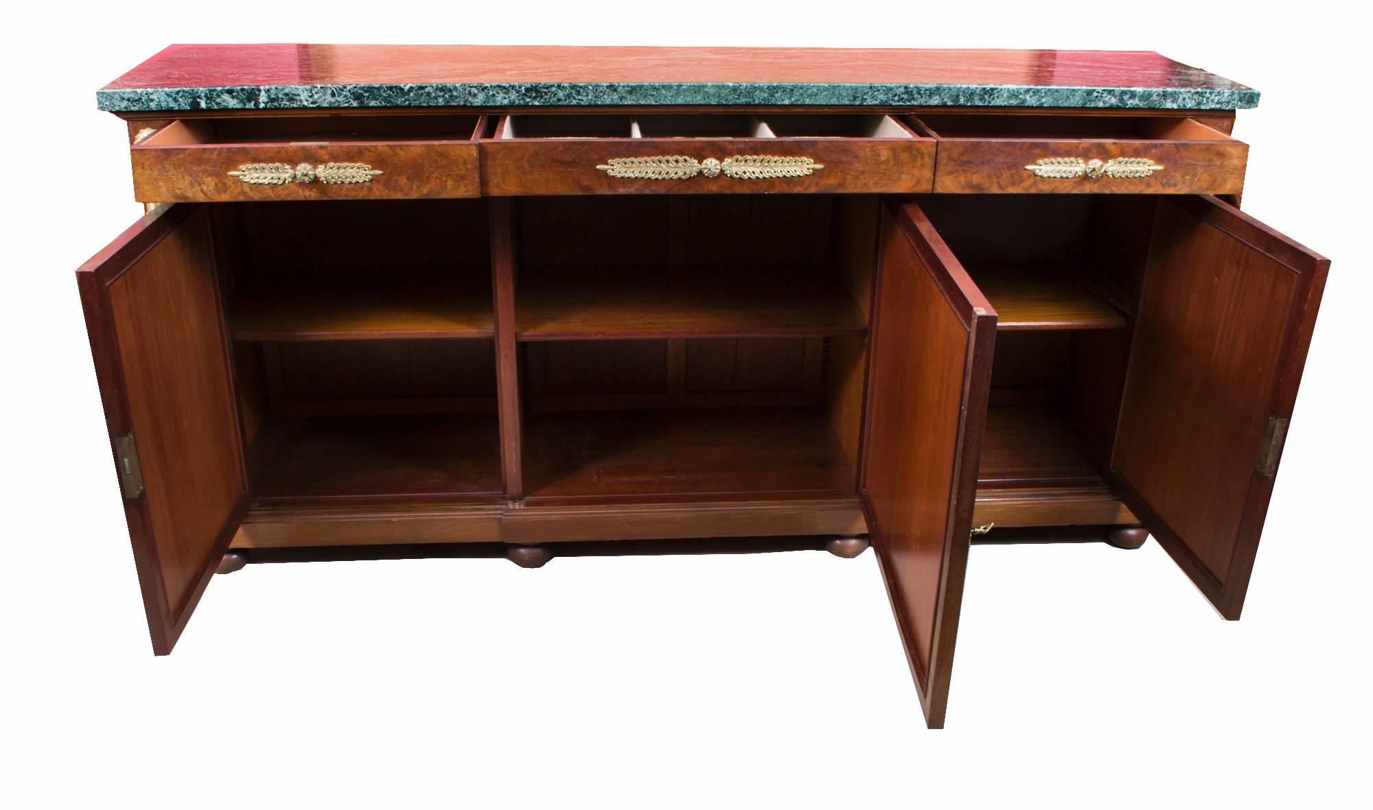 This is an exceptional antique Empire style and ormolu-mounted marble topped breakfront sideboard, circa 1880 in date, with room for all your plates, china, glassware and cutlery.

It has three useful and capacious drawers in the frieze, the