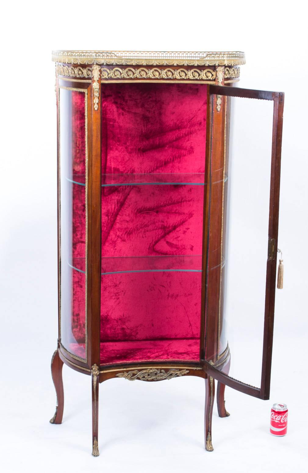 This is a beautiful antique French mahogany and ormolu-mounted display cabinet in the French Louis XV manner, circa 1880 in date.

This beautiful cabinet has an abundance of exquisite ormolu mounts.

It has shaped glass to the front and sides,