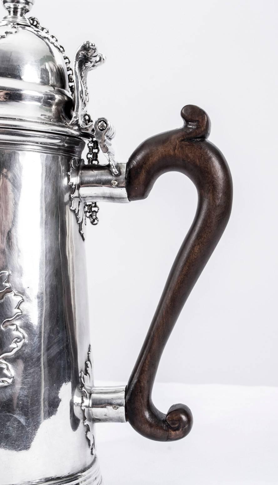 This is a wonderful and rare antique Brittania silver cut card chocolate pot with hall marks for London 1704 and the makers mark CR which stands for Christopher Canner the 1st, registered his mark for New Standard in April 1697.

The pot is of