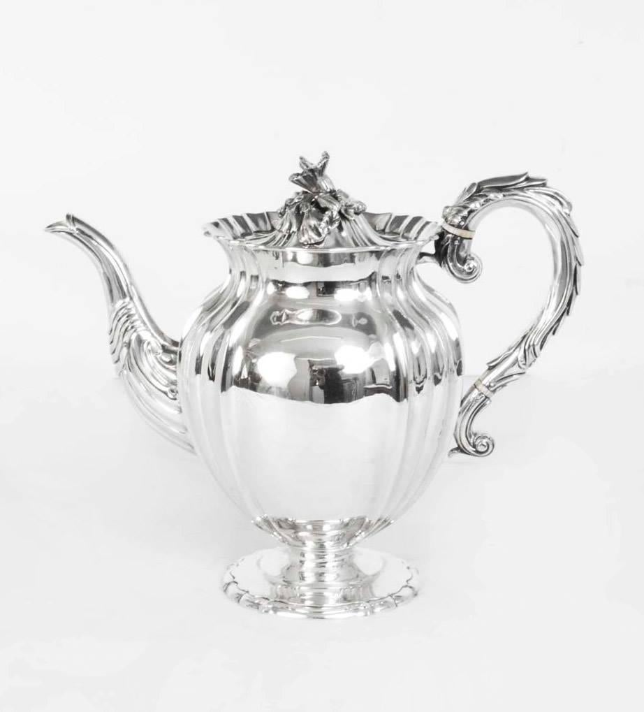 This is a beautiful English antique George III silver coffee pot with wonderful embossed decoration. It has hallmarks for London 1827 and the makers mark of William Elliott.

With it's fabulous elaborate engraved coat of arms, see below, there is