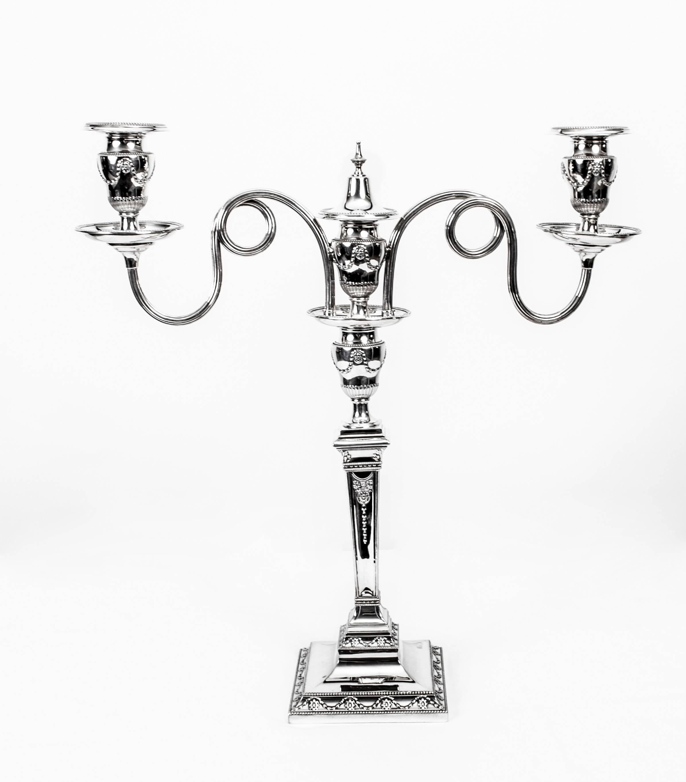 This is a stunning pair of antique Victorian Adam style silver plated, two-light, table candelabra bearing the maker's mark of the renowned silversmith Hawksworth, Eyre & Co, circa 1860 in date. This mark was used by Hawksworth Eyre from