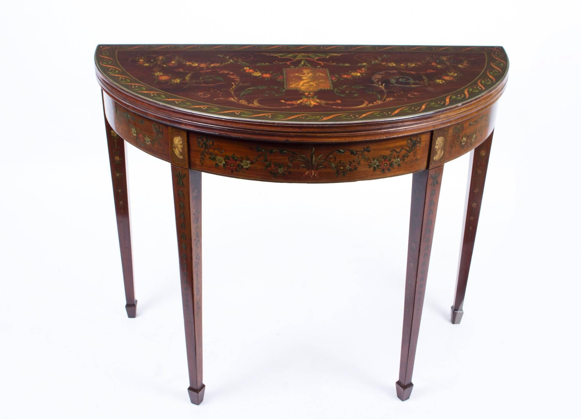 This is a beautiful antique Victorian hand-painted mahogany half moon card table, circa 1870 in date and in superb George III style..

The card table has beautiful neoclassical hand-painted decoration in the manner of Angelica Kauffman, the top