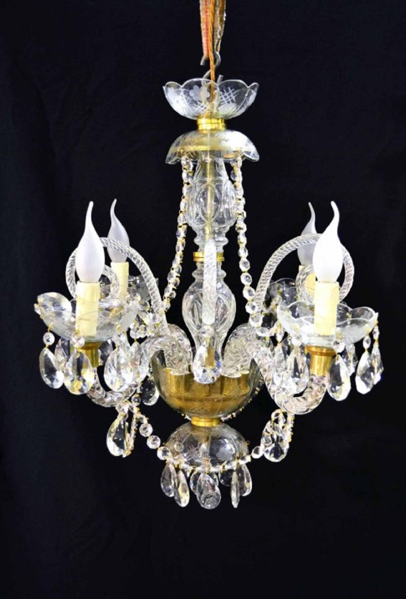 A beautiful pair of small vintage Venetian style crystal chandeliers with four lights each and beautiful clear crystal drops.

They are in fantastic condition they have been dismantled, cleaned and rewired.
Add a touch of class to your home with