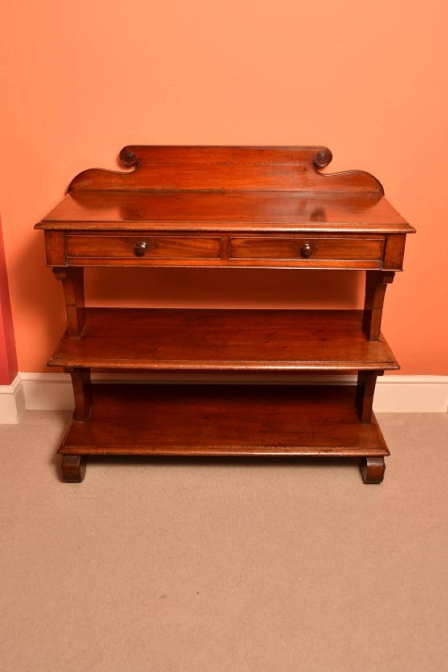 This is an antique Victorian mahogany serving table or buffet, circa 1850 in date.

It is made from mahogany, has a moulded top with twin frieze drawers over two tiered shelves and is raised on beautiful scroll feet.

This is a very unusual item and