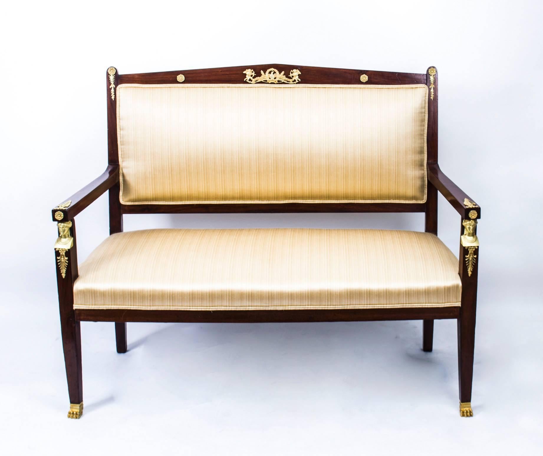 This is a fabulous and highly decorative antique French Empire three-piece salon suite, comprising a sofa and a pair of armchairs, circa 1880 in date.

It has been crafted from fabulous solid mahogany and is smothered in fabulous high quality ormolu