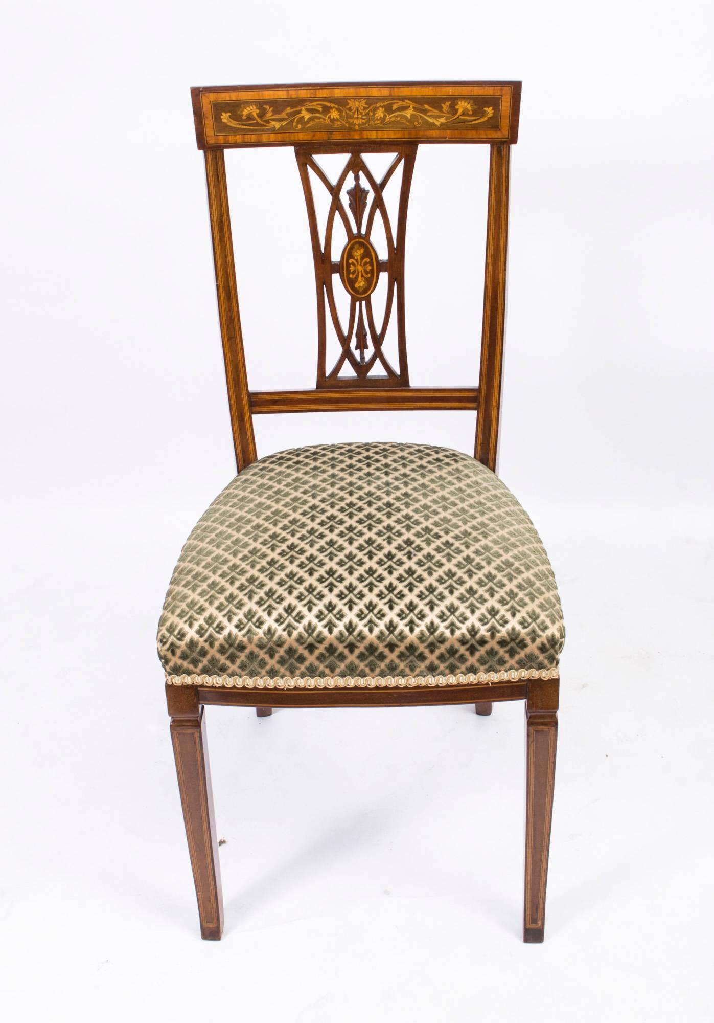 This is a rare set of six antique Edwardian dining chairs, circa 1900 in date.

These chairs have been masterfully crafted in beautiful solid mahogany with satinwood banding and exquisite floral marquetry decoration. 

The set comprises two