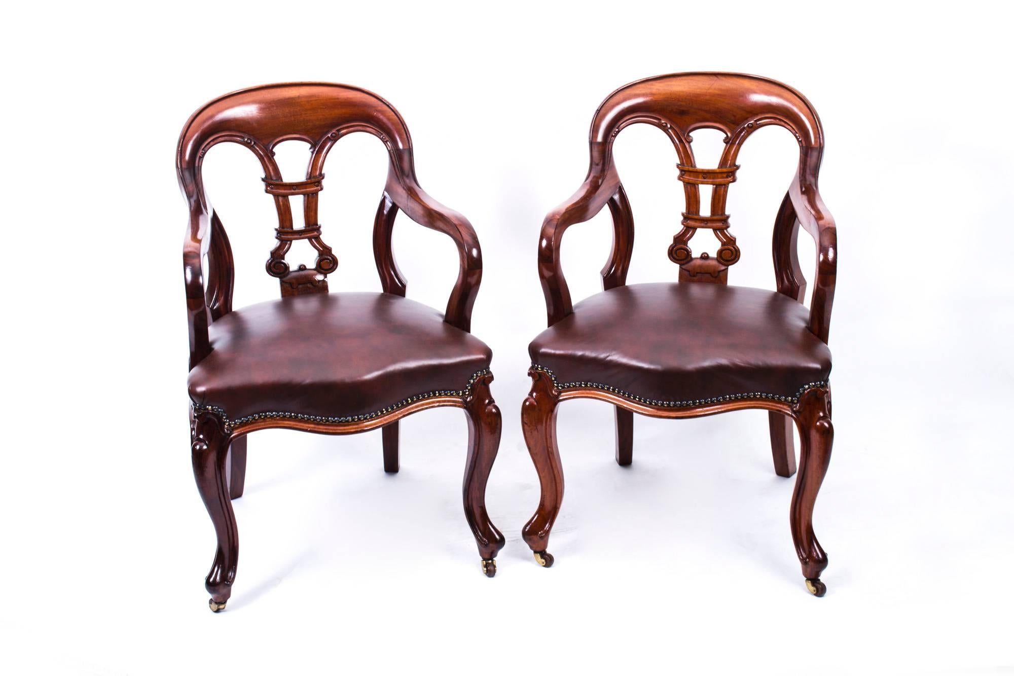 This is an impressive and rare pair of William IV Cuban flame mahogany library elbow chairs, circa 1830 in date.

Each with a stylish shaped and curved top rail with an interlaced and scroll splat with downswept arms that have a wonderful curve
